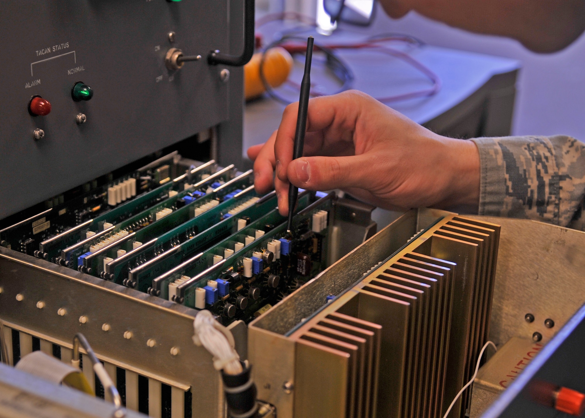Airman 1st Class Eli Romesburg, 92nd Operations Support Squadron airfield systems specialist, adjusts a sensor in the Tactical Air Navigation July 14, 2015, at Fairchild Air Force Base, Wash. Romesburg adjusts the pulse pair rate inside the TACAN monitor to ensure the system is functioning at 100 percent. The TACAN radiates a signal allowing military aircraft up to 200 nautical miles away to locate and navigate toward Fairchild. (U.S. Air Force photo/Airman 1st Class Taylor Bourgeous)