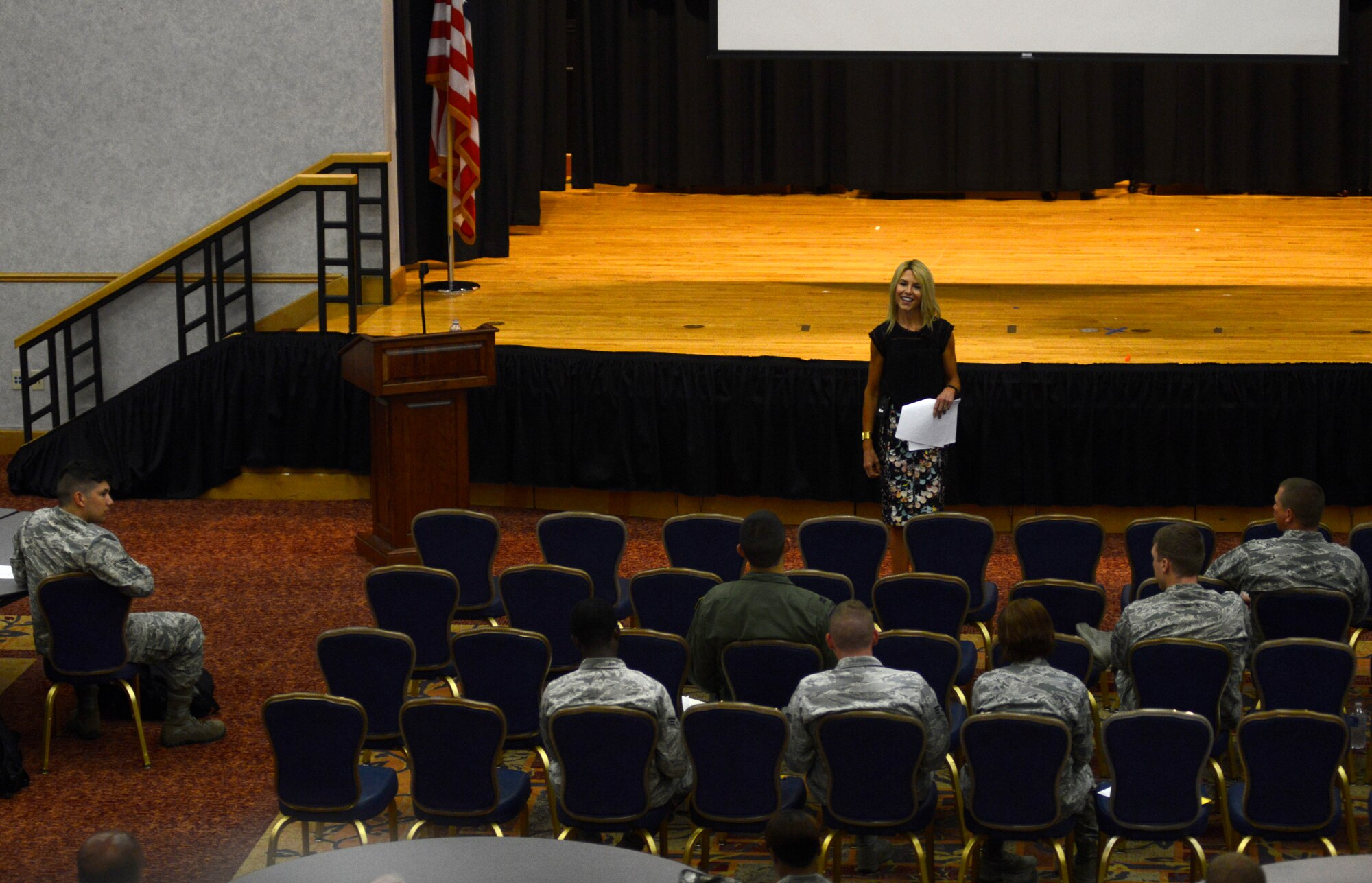 Audrey Curtis Hane, Dean of Graduate Studies at Newman, Kan., speaks to Airmen about the relationship between success and happiness, July 15, 2015, at McConnell Air Force Base, Kan. Hane was one of 15 speakers scheduled to talk to Team McConnell members about topics ranging from success to returning about adversity. “So many people spend their lives on autopilot and only notice the positives when they’re extraordinary,” Hane said. “When a positive event occurs we need to savor the moment, appreciate it and reflect on it later on.” (U.S. Air Force photo by Senior Airman Trevor Rhynes)