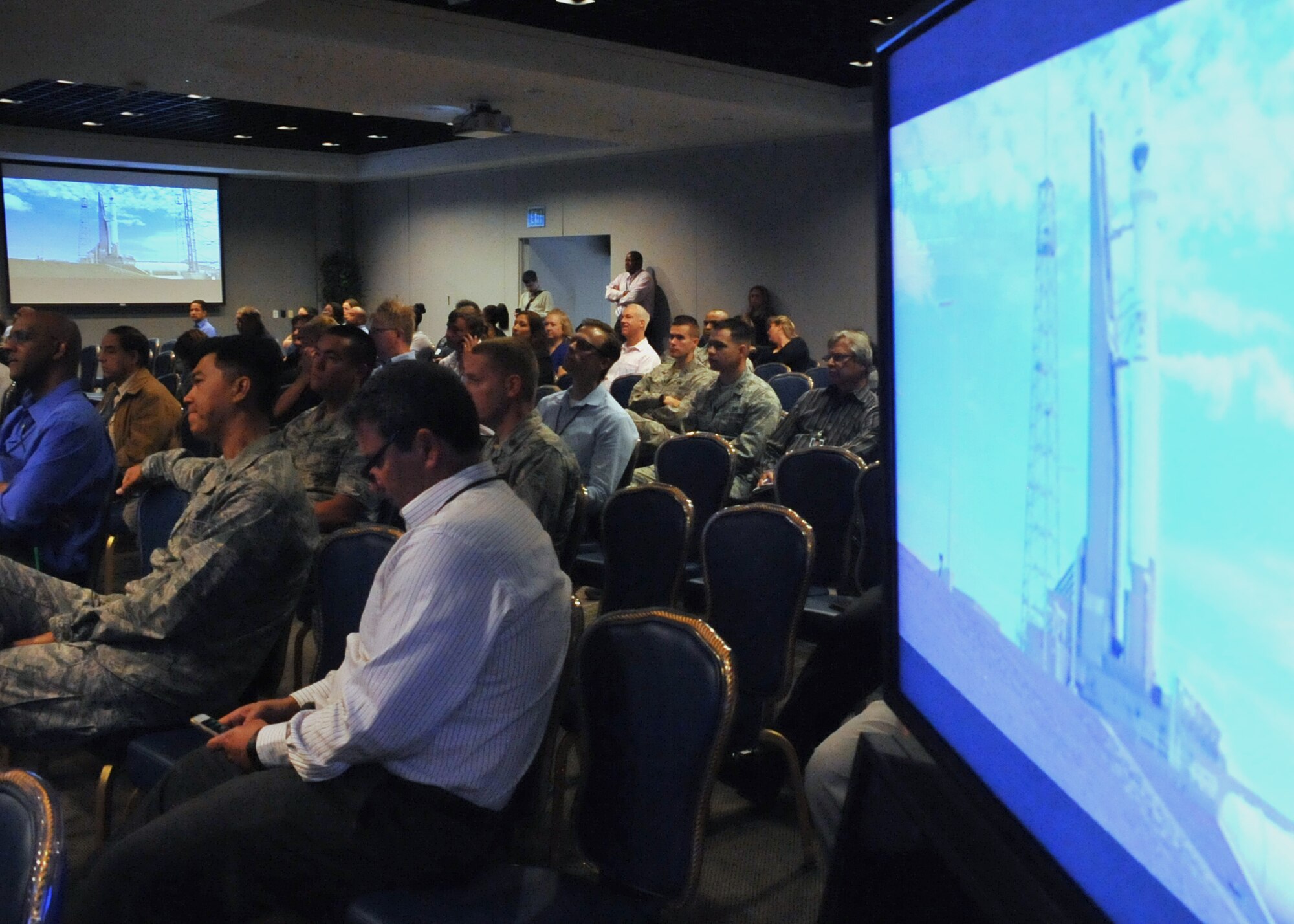 An audience of more than 150 Space and Missile Systems Center personnel intently watch the terminal countdown of an Atlas V in the Gordon Conference Center at Los Angeles Air Force Base in El Segundo, Calif. On July 15, 2015, a United Launch Alliance Atlas V in the “401” vehicle configuration of a four-meter-wide payload fairing, zero solid rocket boosters and a single engine upper stage successfully carried a GPS IIF-10 satellite into orbit at 11:36 a.m. EDT from Launch Complex 41 at Cape Canaveral Air Force Station in Florida for the Global Positioning System navigation network. (U.S. Air Force photo/Sarah Corrice)