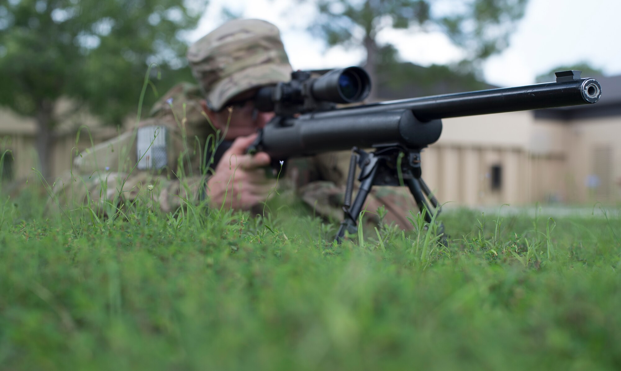 U.S. Air Force Staff Sgt. Joseph Crotty, 822d Base Defense Squadron NCO in charge of standards and evaluations, gazes down the sights of his M24 Sniper Weapon System while in the prone position July 2, 2015, at Moody Air Force Base, Ga. Crotty and Senior Airman Phillip Hopkins, 822d Base Defense Squadron fireteam leader, attended a nine-week sniper training course to develop their knowledge and skills. (U.S. Air Force photo by Staff Sgt. Eric Summers Jr./Released)