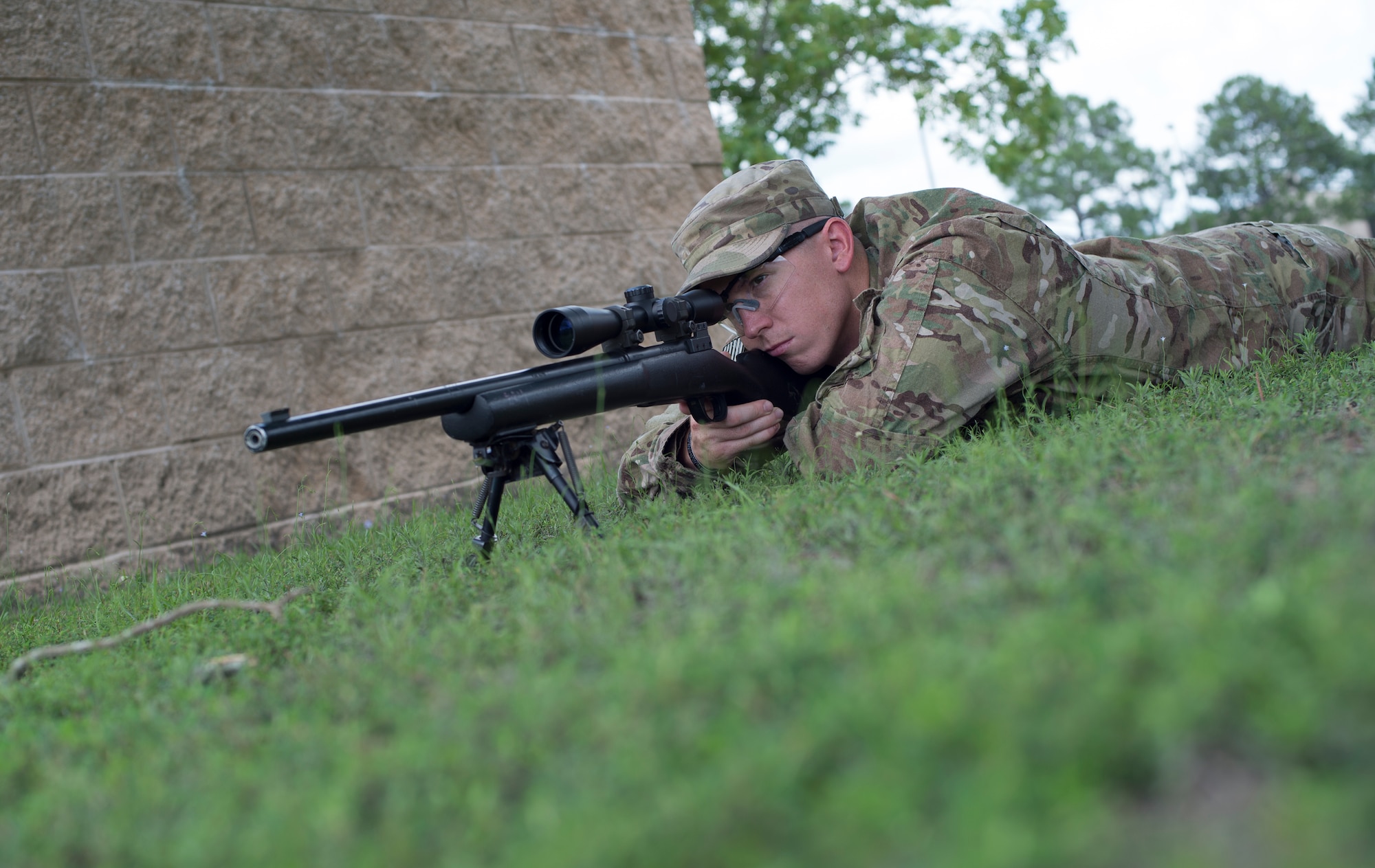 U.S. Air Force Staff Sgt. Joseph Crotty, 822d Base Defense Squadron NCO in charge of standards and evaluations, demonstrates the prone position July 2, 2015, at Moody Air Force Base, Ga. Crotty attended England’s basic sniper course where he learned intelligence gathering and observational skills to be force multiplier on the battlefield. (U.S. Air Force photo by Staff Sgt. Eric Summers Jr./Released)