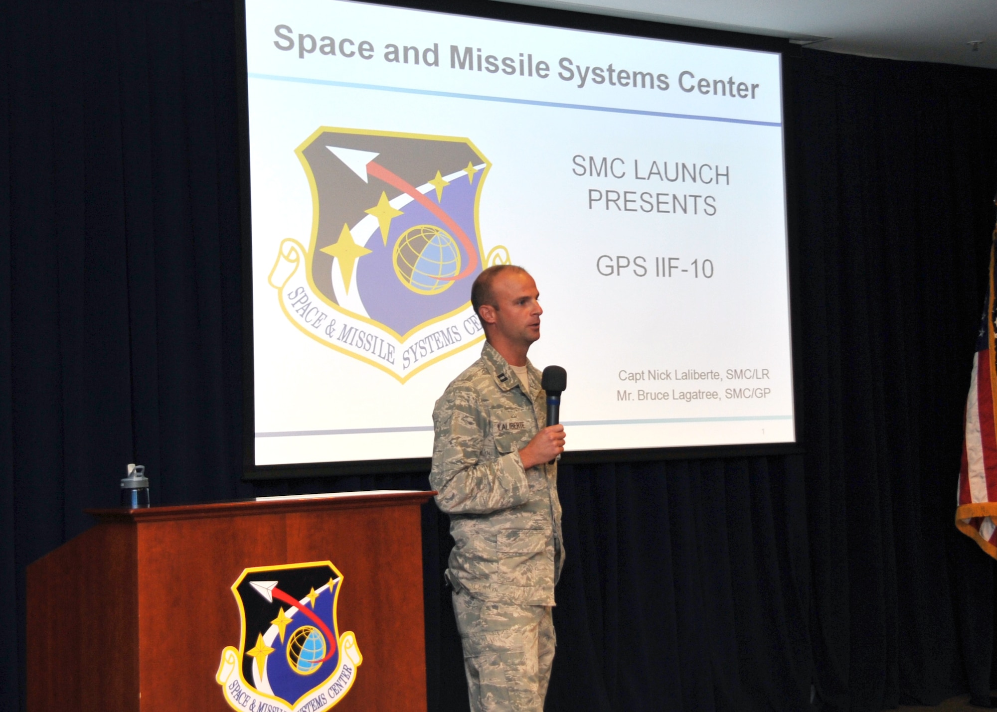 Capt. Nick Laliberte, Government Mission Integration Manager from the Space and Missile Systems Center’s Launch Systems Directorate provides a pre-launch briefing to an audience of more than 150 SMC personnel in the Gordon Conference Center at Los Angeles Air Force Base in El Segundo, Calif. On July 15, 2015, a United Launch Alliance Atlas V in the “401” vehicle configuration of a four-meter-wide payload fairing, zero solid rocket boosters and a single engine upper stage successfully carried a GPS IIF-10 satellite into orbit at 11:36 a.m. EDT from Launch Complex 41 at Cape Canaveral Air Force Station in Florida for the Global Positioning System navigation network. (U.S. Air Force photo/Sarah Corrice)