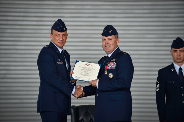 Colonel John Lamontagne (left), 437th Airlift Wing commander, presents a Legion of Merit to Col. Fred Boehm July 15, 2015, during the 437th Operations Group change of command at Joint Base Charleston, S.C. Boehm has served as the 437th OG commander since July 2013. Following the change of command, Boehm’s next assignment will take him to Saudi Arabia where he will be the chief of the Joint Advisory Division for Saudi Arabia. (U.S. Air Force photo/Senior Airman Jared Trimarchi) 

