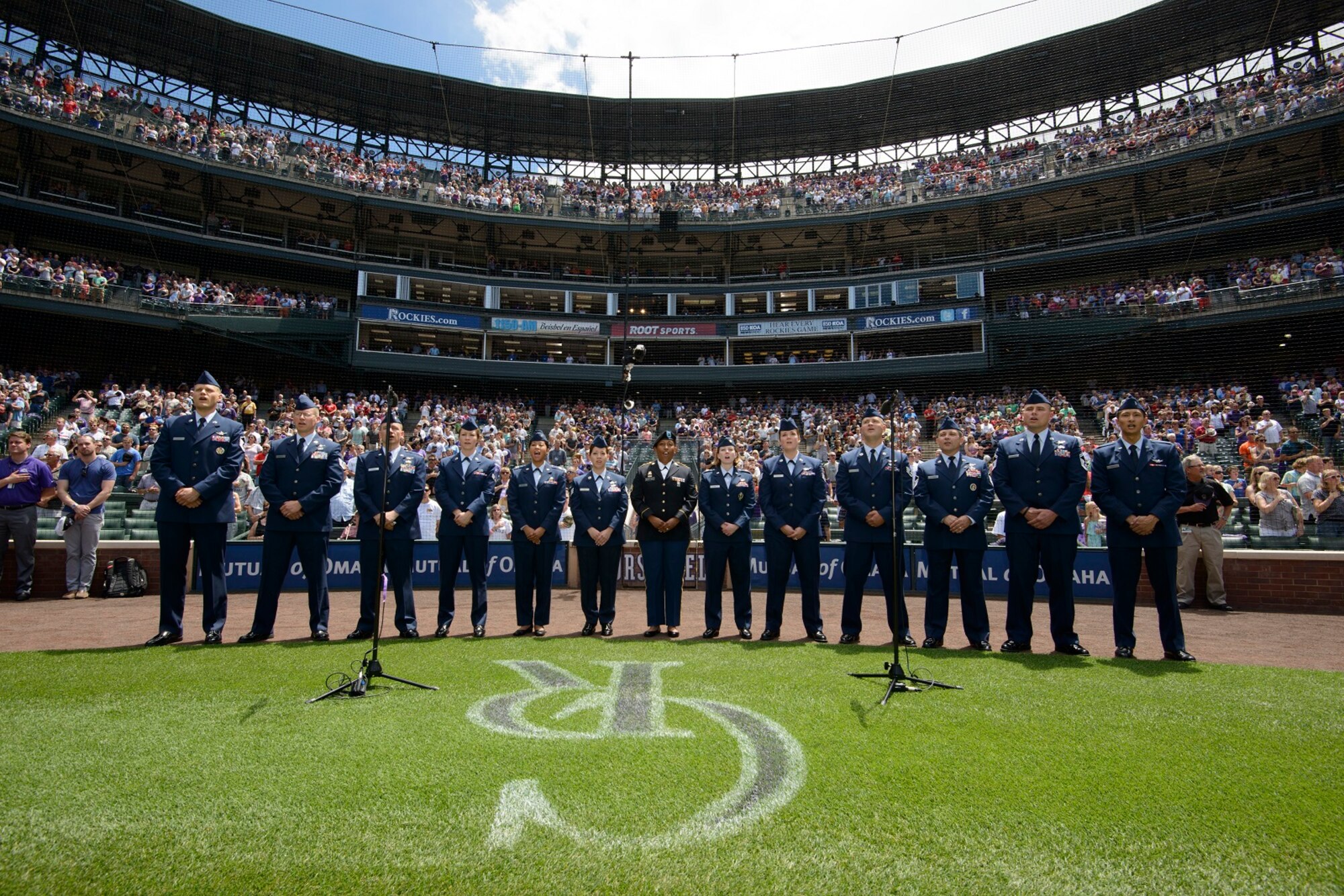 Military members from Buckley Air Force Base, including several Air Force Reservists from the 8th Space Warning Squadron, sing the national anthem before the Colorado Rockies game July 11, 2015.  The Airmen were part of the Rockies Military Appreciation Day game at Coors Field, Denver, Colorado.  (Courtesy Photo)
