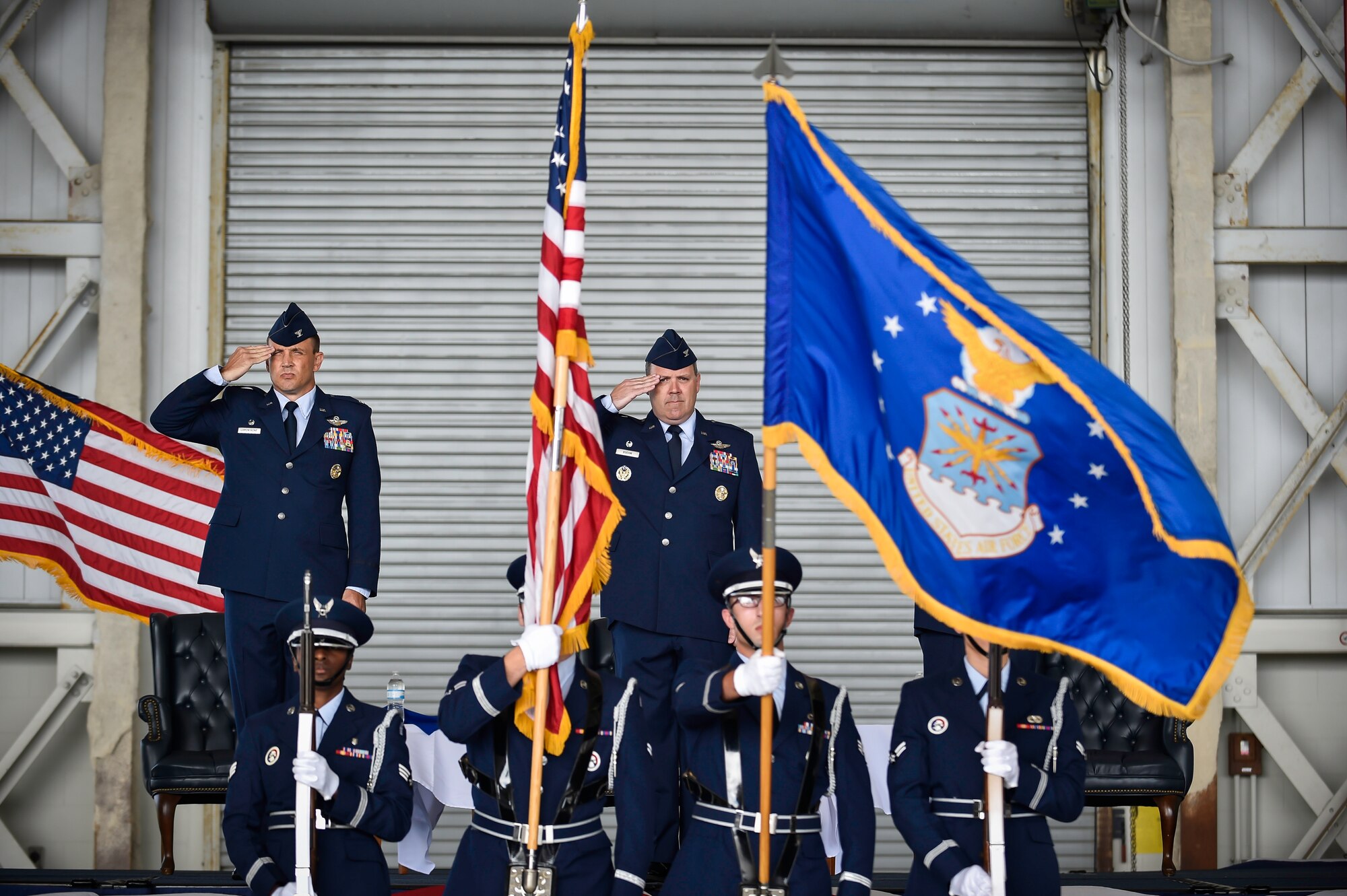 Colonel John Lamontagne (left) and Col. Fred Boehm salute the flag July 15, 2015, during the 437th Operations Group change of command at Joint Base Charleston, S.C. Boehm has served as the 437th OG commander since July 2013.  Following the change of command, Boehm’s next assignment will take him to Saudi Arabia where he will be the chief of the Joint Advisory Division for Saudi Arabia. Lamontagne is the 437th Airlift Wing commander. (U.S. Air Force photo/Senior Airman Jared Trimarchi) 

