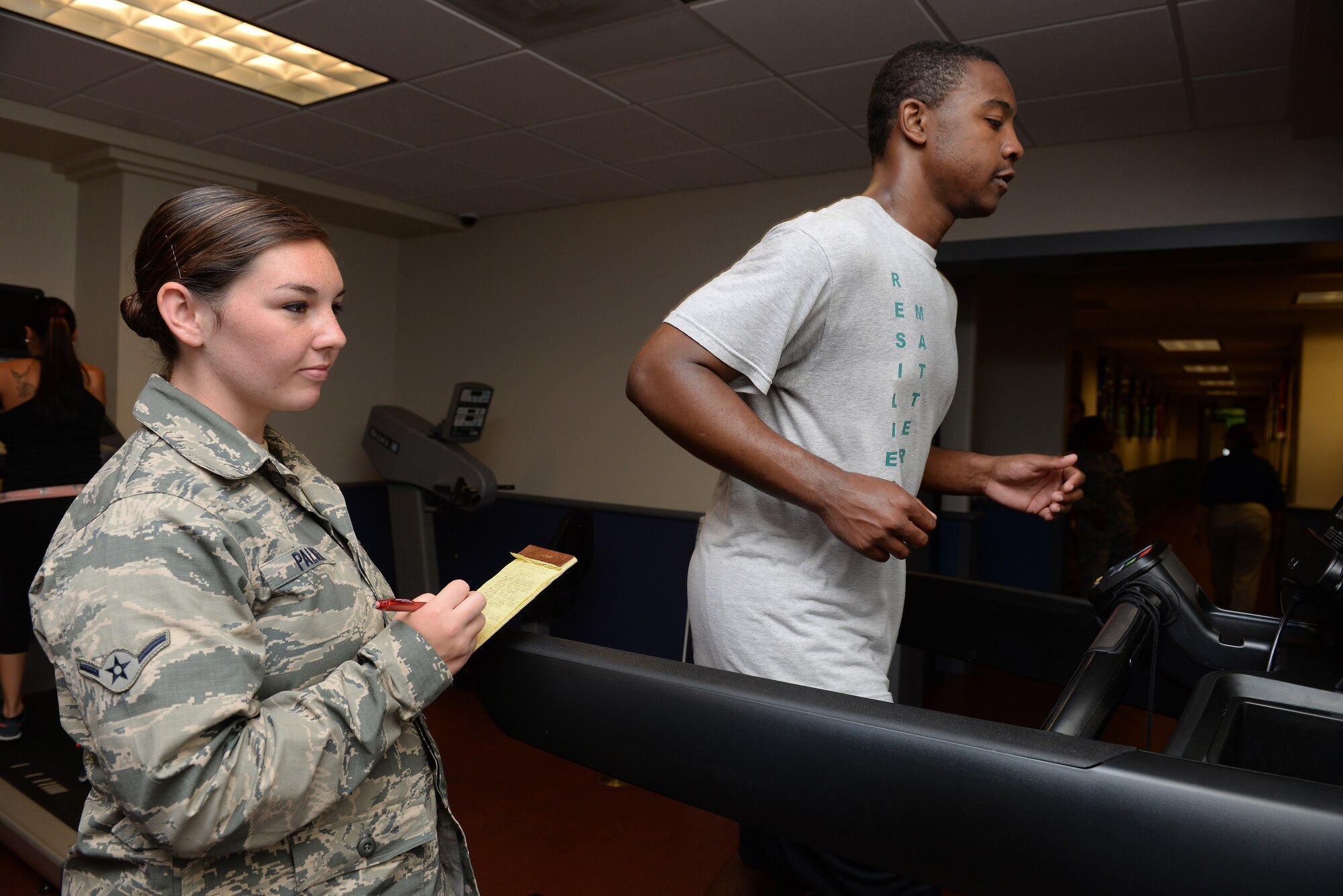 Amn Kelsey Palmer, 375th Force Support Squadron Fitness Technician, times a runner at the James Sports Center, Scott Air Force Base, Illinois, July 7, 2015. Palmer recently went through training to earn her Personal Trainer certification to better help others reach their fitness goals. (U.S. Air Force photo by Airman 1st Class Erica Holbert-Siebert)