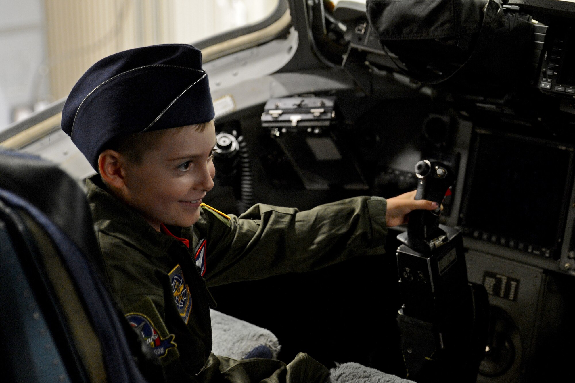 Ewan McFadgen, Pilot for a Day, sits in the pilot seat of a C-17 Globemaster III July 10, 2015, during his tour of Joint Base Lewis-McChord, Wash. McFadgen and his family explored the aircraft before concluding their tour with a C-17 flight simulator. (U.S. Air Force photo/Airman 1st Class Keoni Chavarria)