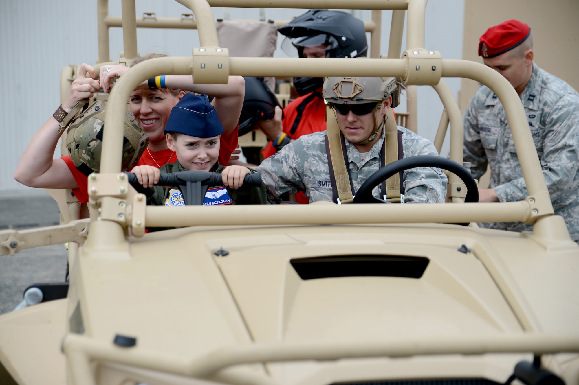 Ewan McFadgen, Pilot for a Day, rides in a light tactical all-terrain vehicle July 10, 2015, during his tour of Joint Base Lewis-McChord, Wash. Along his tour, McFadgen and his family learned about the various missions and responsibilities of the squadrons on McChord Field. (U.S. Air Force photo/Airman 1st Class Keoni Chavarria)