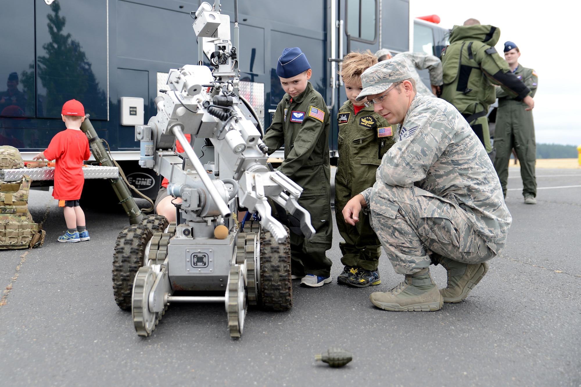 Ewan McFadgen, Pilot for a Day, controls a 627th Civil Engineer Squadron Explosive Ordinance Disposal F-6A robot July 10, 2015, during his tour of Joint Base Lewis-McChord, Wash. The EOD F-6A robot is used by the 627th CES EOD team when dealing with explosives or unknown packages. (U.S. Air Force photo/Airman 1st Class Keoni Chavarria)