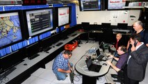 Technical experts, including members of Hanscom Air Force Base's Tactical Data Networks lab, work on integrating Efficient XML/Mobility Airborne-networking Multi-Layer Sensing, or EFX/MAMLS, into the Dynamic Retasking Capability system on a 143rd Airlift Wing C-130J aircraft during a test event at the Hanscom Collaboration and Innovation Center in June. The event used a new initiative, the Northeast Collaborative Research, Development, Test and Evaluation Environment, known as NCORE, to bring together assets and expertise from the Air Force Life Cycle Management Center and New England National Guard units. Hanscom’s TDN lab is the conduit for NCORE. (U.S. Air Force photo by Steve O’Neil.)