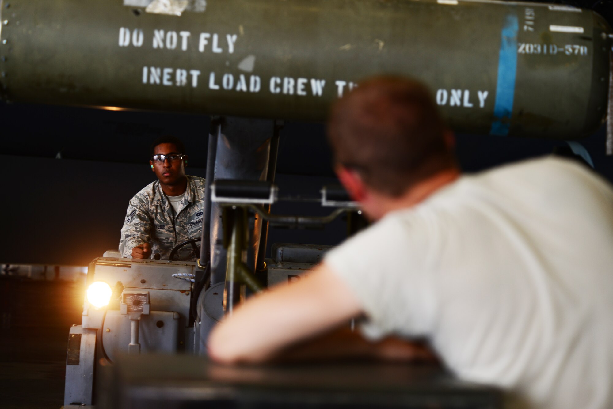 Senior Airman Perry Naylor II and Airman 1st Class Jeffrey Aleo, 2nd Aircraft Maintenance Squadron, work together to position a CBU-103 during a load crew of the quarter competition at Barksdale Air Force Base, La., July 10, 2015. The CBU-103 weighs around 900 pounds and is effective against armor, personnel and soft-skin targets. (U.S. Air Force photo/Airman 1st Class Luke Hill)