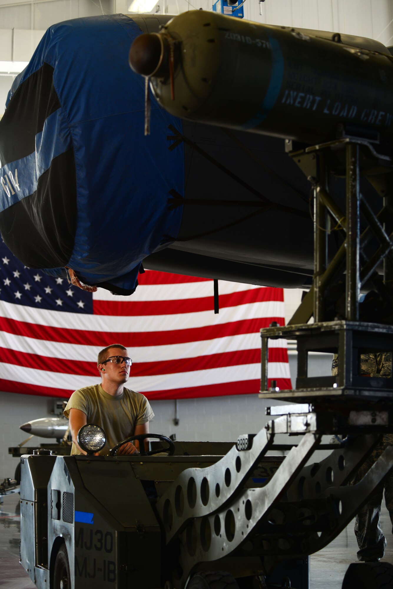 Airman 1st Class Jeffrey Aleo, 2nd Aircraft Maintenance Squadron, maneuvers the CBU-103 into place so that team Cobra 7 can mount the cluster bomb onto a B-52 Stratofortress during a load crew of the quarter competition at Barksdale Air Force Base, La., July 10, 2015. The B-52, known for its long range and devastating combat capabilities, is a symbol of U.S. air power. (U.S. Air Force photo/Airman 1st Class Luke Hill)