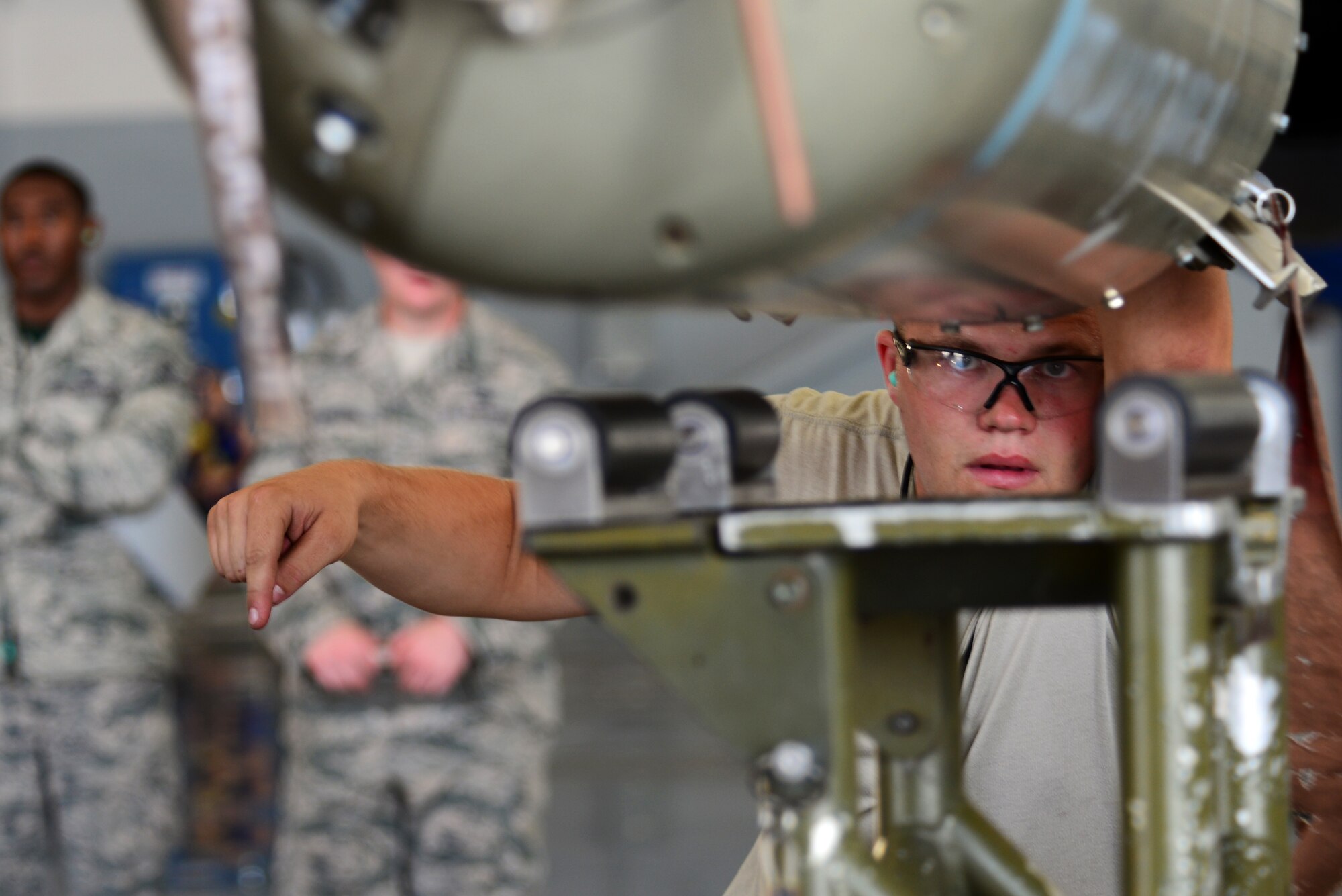 Senior Airman David Hansen, 2nd Aircraft Maintenance Squadron, guides a CBU-103 onto a lift during a load crew of the quarter competition at Barksdale Air Force Base, La., July 10, 2015. The CBU-103’s wind corrected munitions dispenser (WCMD) guidance tail kit, makes it a precision-guided weapon. (U.S. Air Force photo/Airman 1st Class Luke Hill)