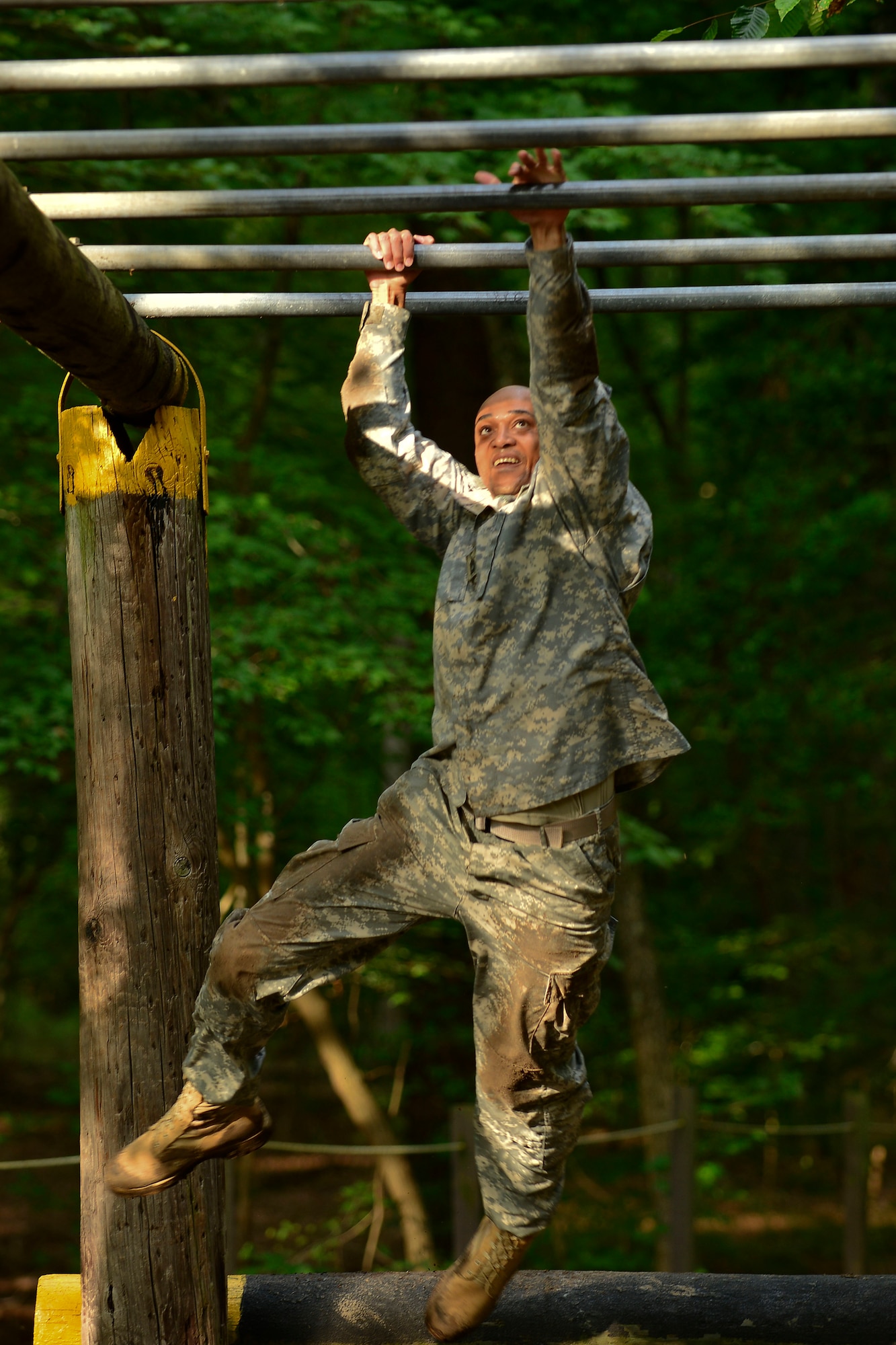 U.S. Army Sgt. 1st Class Cedric Ridgeway, 128th Aviation Brigade 1st-210th Aviation Regiment instructor, crosses monkey bars during the Highlander Challenge at Fort Eustis, Va., July 13, 2015. Crossing the monkey bars was a part of the obstacle course, which was the first station of the five-part challenge. (U.S. Air Force photo by Staff Sgt. Natasha Stannard/Released)


