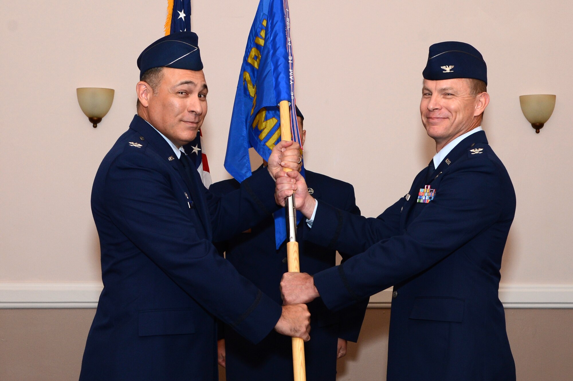 Col. Scott Price assumes command of the 2nd Aerospace Medical Squadron from Col. Ender Ozgul, 2nd Medical Group commander, during a change of command ceremony at Barksdale Air Force Base, La., July 10, 2015. The change of command ceremony is a military tradition that represents a formal transfer of authority and responsibility of a unit from one commanding officer to another. Price previously served as the chief of aerospace medicine, 31st Medical Group, Aviano Air Base, Italy. There he was responsible for all Team Aerospace activities supporting the operational mission and policies governing aerospace, occupational, deployment, disaster and preventative medicine. (U.S. Air Force photo/Senior Airman Joseph A. Pagán Jr.)
