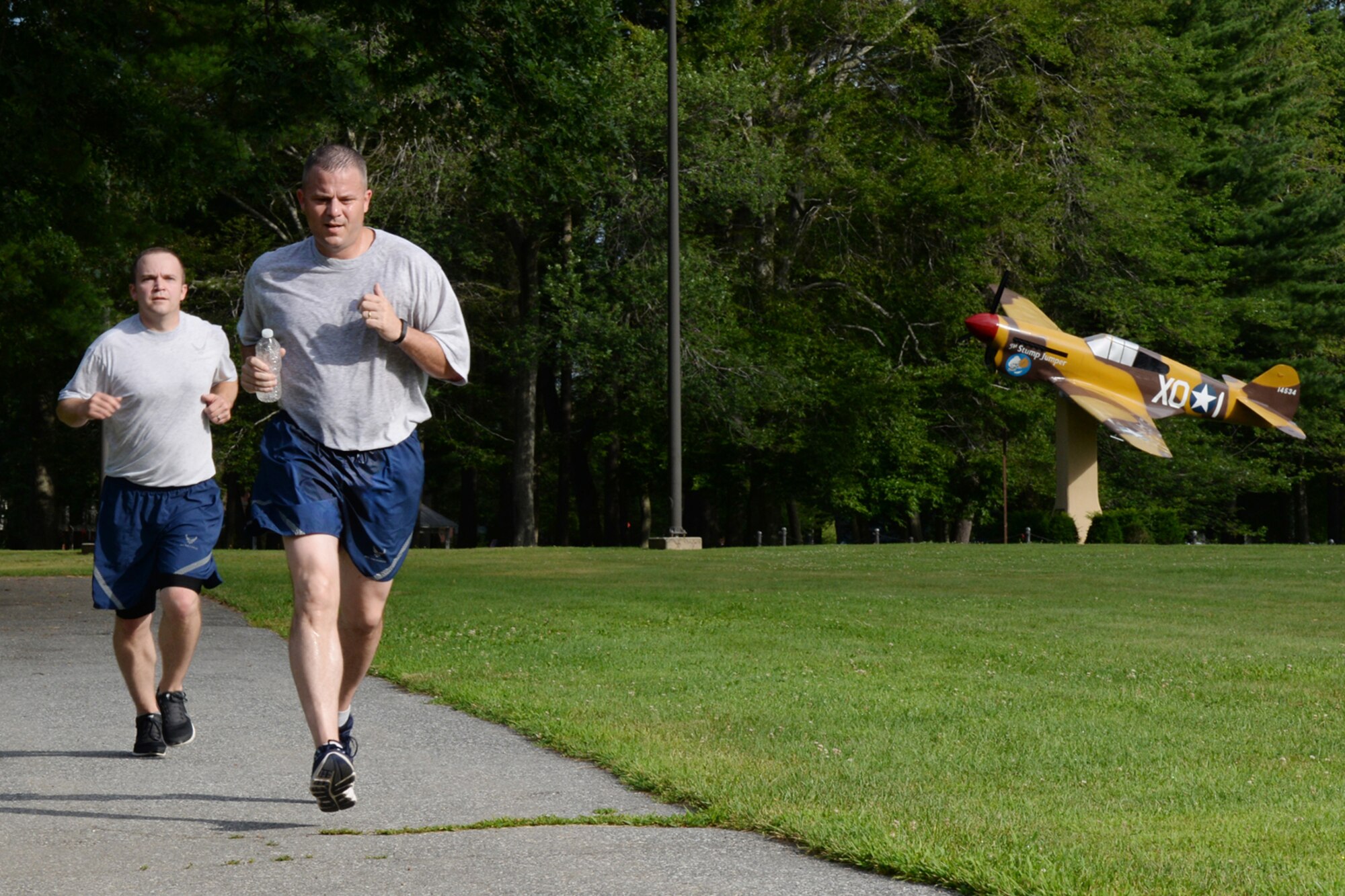 Chief Master Sgt. David Anthony, 319th Recruiting Squadron superintendent, and Staff Sgt. Jesse Ranslow, 319 RCS training NCO, run through Castle Park during the Firecracker 5K Run on July 15. Capt. Kyle Larson, C3I and Networks Directorate, placed first for the men with a run time of 17:44, while Katy Murray, came in first for the women, running the in 24:07. (U.S. Air Force photo by Linda LaBonte Britt)