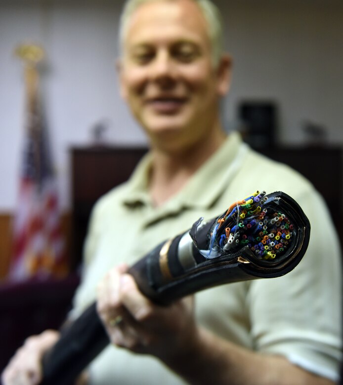 Michael Best, 341st Missile Maintenance Squadron chief of cable affairs and Hardened Intersite Cable Systems maintenance sections, holds a missile field cable July 7, 2015. More than 2,400 miles of cable cross nine counties, eight major river systems and six mountain ranges throughout central Montana to provide information technology and resources to operate and maintain command and control systems for Malmstroms Air Force Base’s Minuteman III intercontinental ballistic missiles (U.S. Air Force photo/Chris Willis)