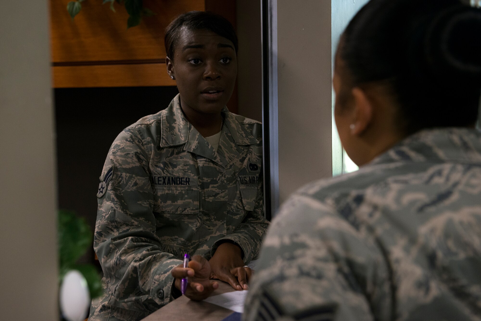 U.S. Air Force Senior Airman Kiandra Alexander, 23d Logistics Readiness Squadron traffic management journeyman, briefs Staff Sgt. Sarita Fair, 23d Force Support Squadron lodging assistant manager, in the traffic management office July 9, 2015, at Moody Air Force Base, Ga. TMO is responsible for moving personal property and cargo movement as well as passenger travel arrangements for PCS, TDY and deployments. (U.S. Air Force photo by Airman 1st Class Kathleen D. Bryant/Released)
