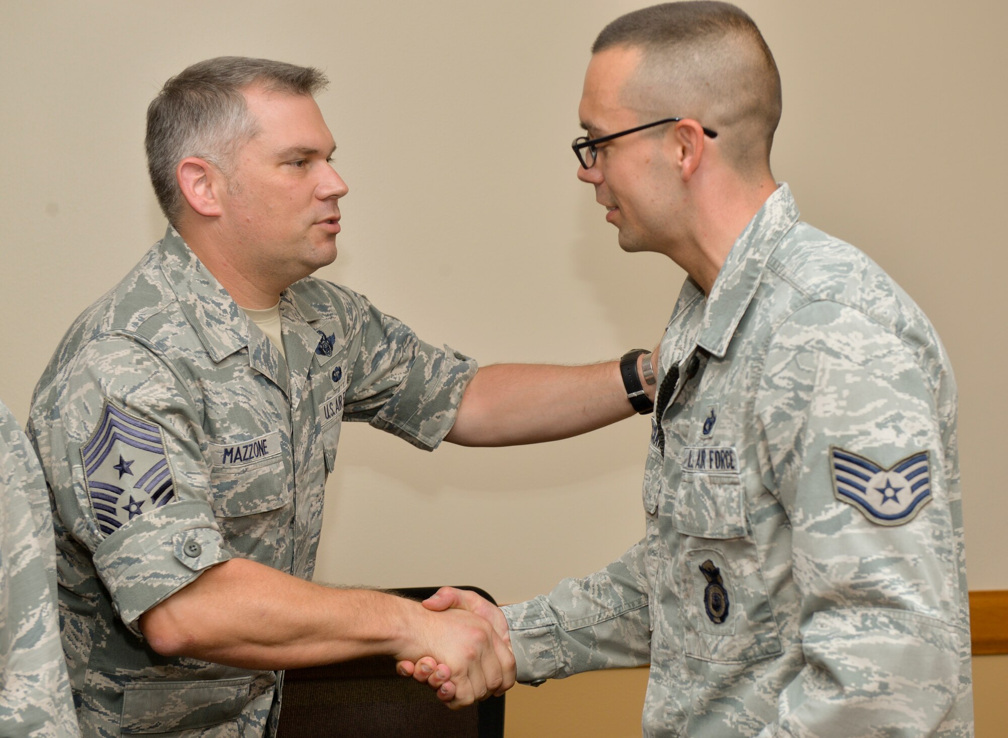 Chief Master Sgt. Tommy Mazzone, 2nd Bomb Wing command chief, welcomes home Staff Sgt. Joe McCraw, 2nd Security Forces Squadron installation patrolman after a deployment to Saudi Arabia at Barksdale Air Force Base, La, July 14, 2015. McCraw and his team conducted security and perimeter patrols for permanent party members stationed at the installation. (U.S. Air Force photo/Airman 1st Class Mozer O. Da Cunha)