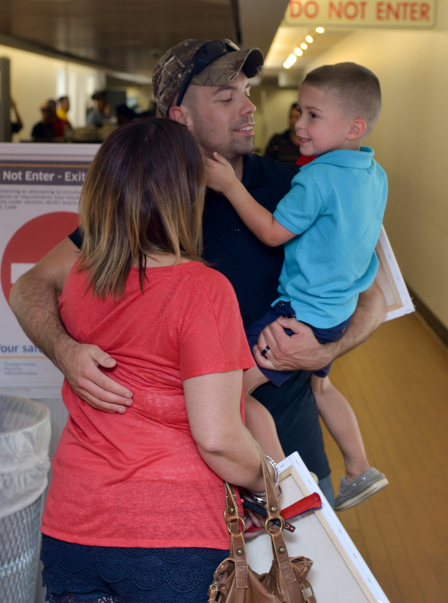 Staff Sgt. Joe McCraw, 2nd Security Forces Squadron installation patrolman, greets his wife and son after a six-month long deployment at Shreveport Regional Airport, Shreveport La., July 13, 2015. Upon his return from a deployment to Saudi Arabia. (U.S. Air Force photo/Airman 1st Class Mozer O. Da Cunha)