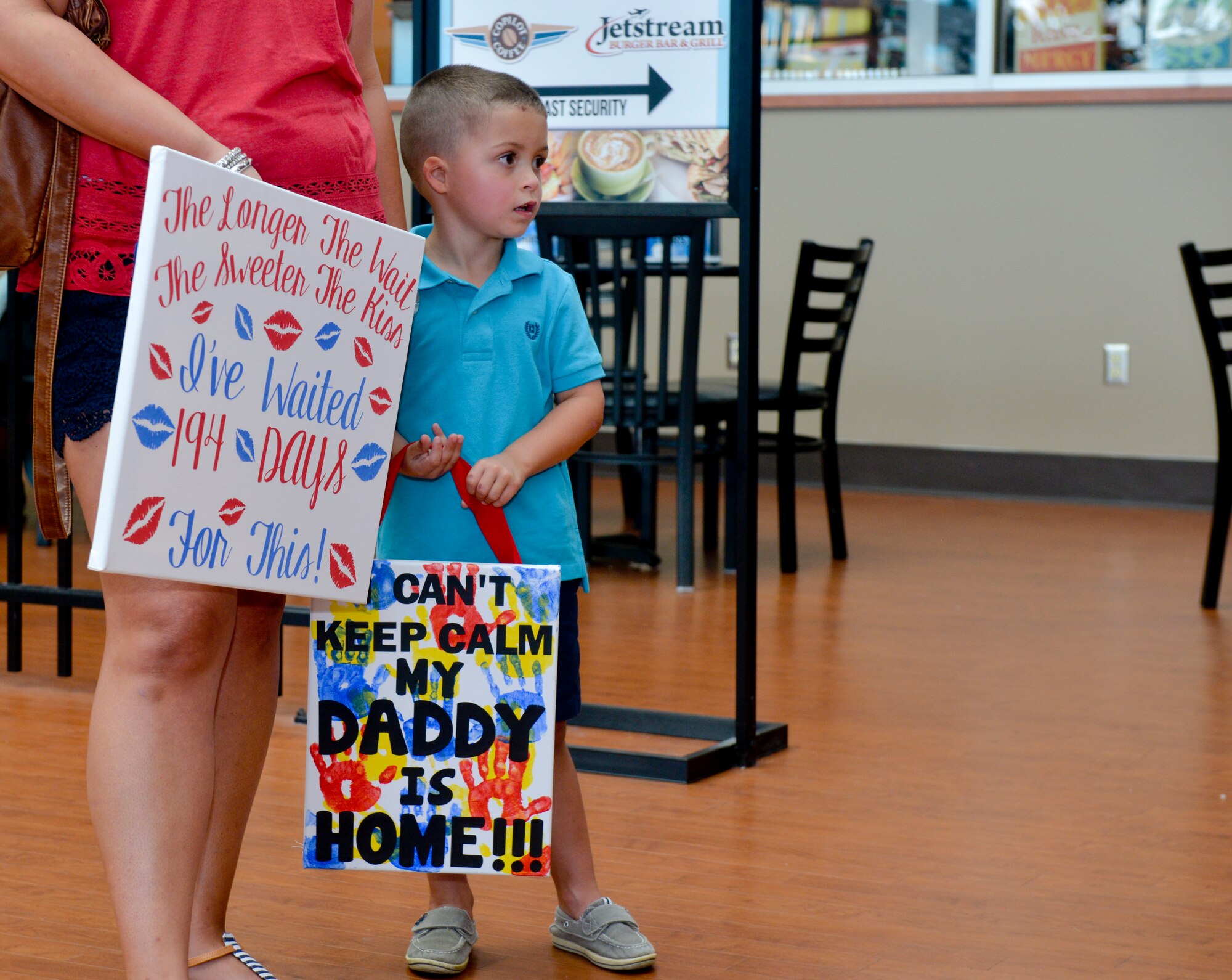 Family members wait for Staff Sgt. Joe McCraw, 2nd Security Forces Squadron installation patrolman, to arrive from the gate at Shreveport Regional Airport, Shreveport, La., July 13, La., 2015. McCraw returned from a 194-day deployment to Saudi Arabia. (U.S. Air Force photo/Airman 1st Class Mozer O. Da Cunha)