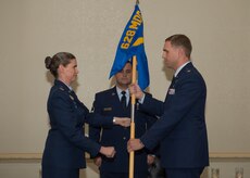 Colonel Margret Jones, 628th Medical Group commander passes the guidon to Lt. Col. Brian Neese, the new 628th Medical Operations Squadron commander during a change of command ceremony July 7, 2015 at Joint Base Charleston, S.C. Neese comes to JB Charleston from Davis Monthan Air Force Base, Az., where he was the chief of  the International Health Specialist Division, Command Surgeon Directorate for the 12th Air Force and Air Forces Southern. The outgoing 628th MDOS commander, Lt. Col. Luis Otero is headed to Maxwell Air Force Base, Al., where he will attend Air War College. (Courtesy Photo) 