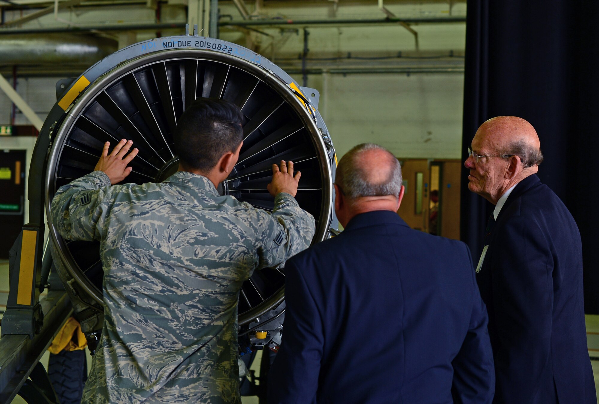 Senior Airman Patric Naranjo, 48th Component Maintenance Squadron aerospace propulsion journeyman, interacts with local British dignitaries during an Honorary Commanders summer reception at Royal Air Force Lakenheath, England, July 10, 2015. The reception allowed local dignitaries and British leaders the chance to visit the base to encourage continual partnership between local key leaders and military communities. (U.S. Air Force photo by Senior Airman Erin O’Shea/Released)