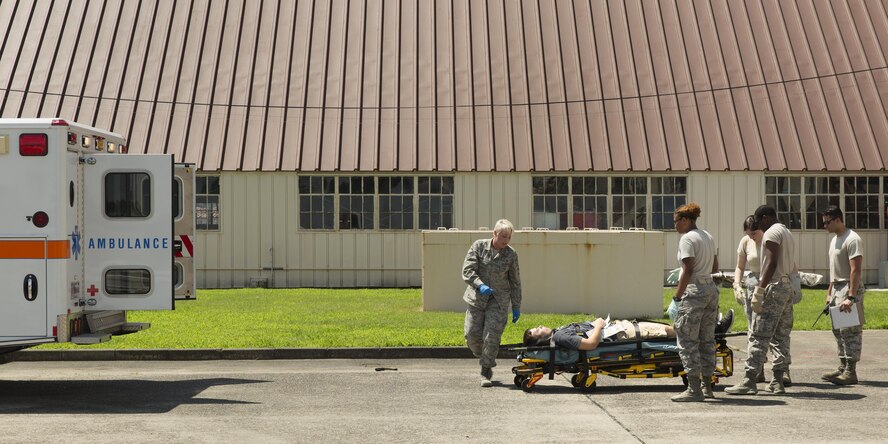 First responders from the 374th Medical Group prepare to transport a simulated victim onto an ambulance during an Emergency Management Exercise at Yokota Air Base, Japan, July 13 ,2015. The EME trained Yokota for possible real-world situations requiring response and communication between on-base organisations. (U.S. Air Force photo by Osakabe Yasuo/Released)
