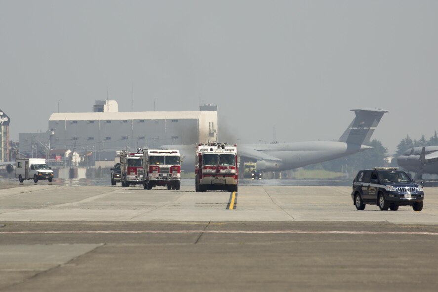 Yokota first responders respond to a simulated aircraft clash site at Yokota Air Base, Japan, July 13, 2015, during an Emergency Management Exercise. The EME prepared Yokota for possible real-world situations requiring response and communication between base organisations. (U.S. Air Force photo by Osakabe Yasuo/Released)