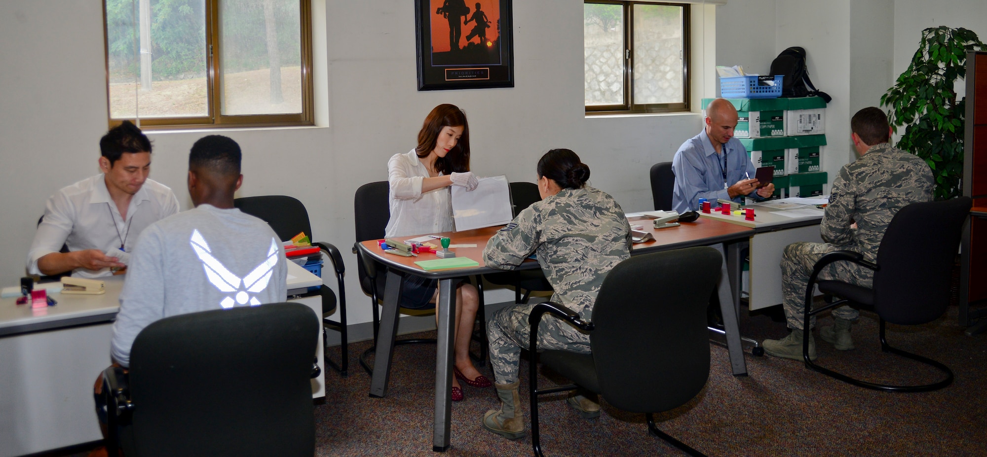 U.S. Embassy representatives process tourist passports for Airmen at the 51st Force Support Squadron military personnel flight on Osan Air Base, Republic of Korea on July 8, 2015. The embassy teamed up with the MPF to process tourist passports on base, thus far processing more than 150 tourist passports for Team Osan. (U.S. Air Force photo/Senior Airman Kristin High)