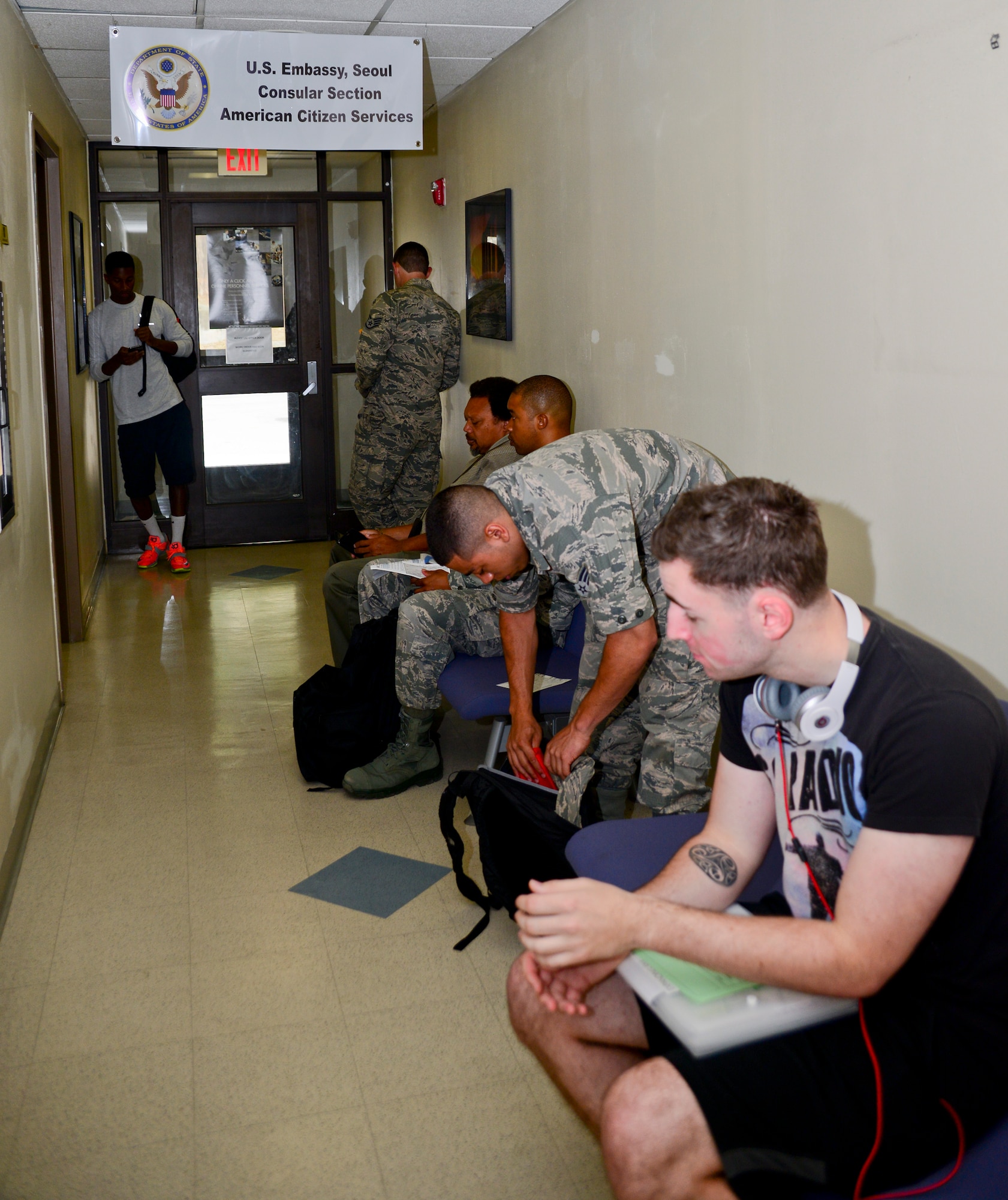 Team Osan members wait in line to process tourist passport applications at the 51st Force Support Squadron military personnel flight on Osan Air Base, Republic of Korea on July 8, 2015. The U.S. embassy will come to the base approximately every three weeks to help Team Osan process tourist passports. (U.S. Air Force photo/Senior Airman Kristin High)