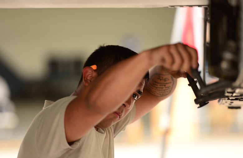 U.S. Air Force Senior Airman David Aguilera, 25th Aircraft Maintenance Unit weapons loader, preps a U.S. Air Force A-10 Thunderbolt II to receive munitions during the quarterly weapons load competition at Osan Air Base, Republic of Korea, July 10, 2015. The event adds an element of competition to a qualification test for the technicians; competitors must complete a written test and a practical demonstration of skill within a fixed amount of time in order to maintain mission readiness status. (U.S. Air Force photo by Staff Sgt. Amber Grimm/Released)