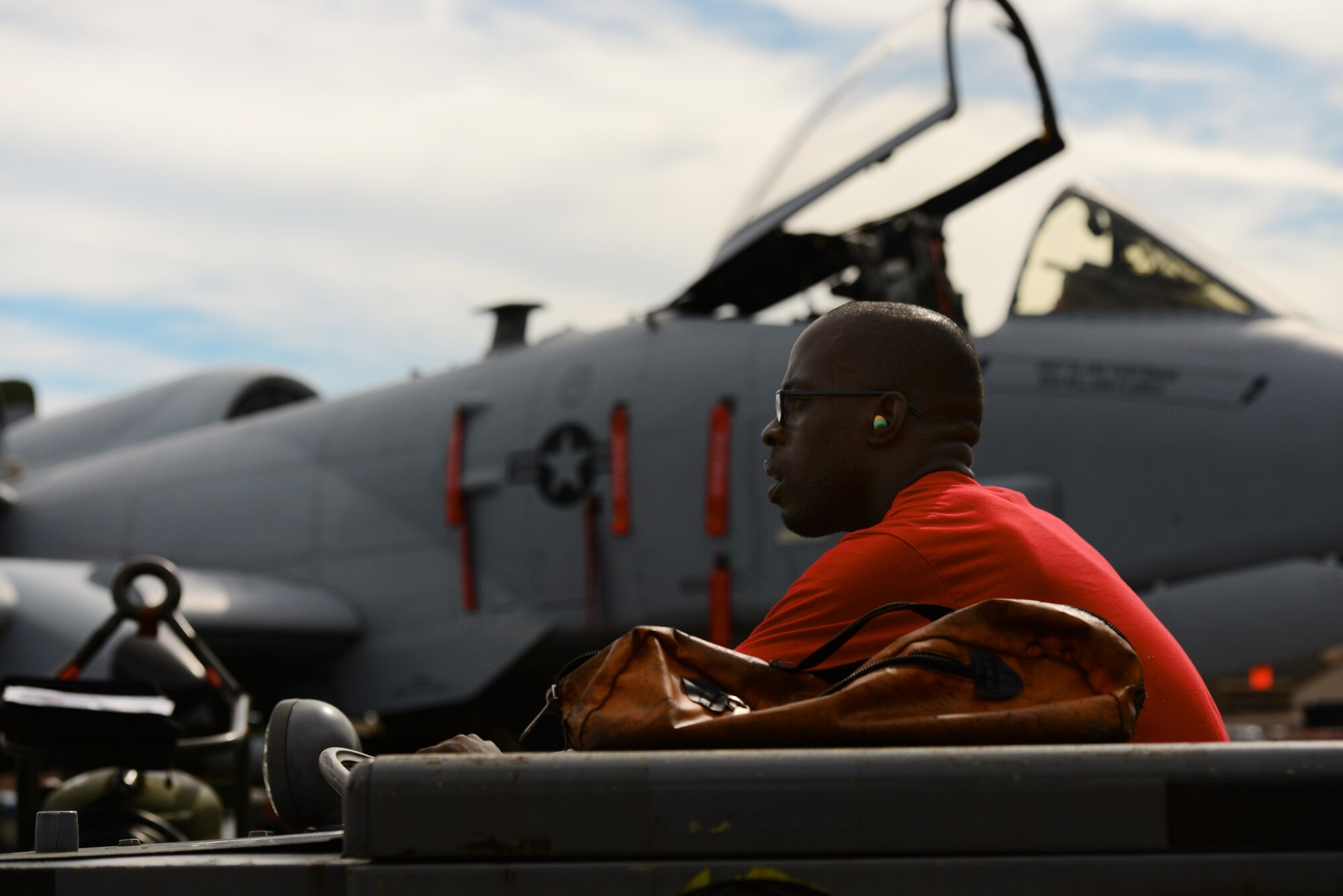 U.S. Air Force Airman 1st Class Jean Moise-Morel, 36th Aircraft Maintenance Unit weapons loader, runs the loader for the winning team during the quarterly competition held at Osan Air Base, Republic of Korea, July 10, 2015. The event adds an element of competition to a qualification test for the technicians; competitors must complete a written test and a practical demonstration of skill within a fixed amount of time in order to maintain mission readiness status. (U.S. Air Force photo by Staff Sgt. Amber Grimm/Released)
