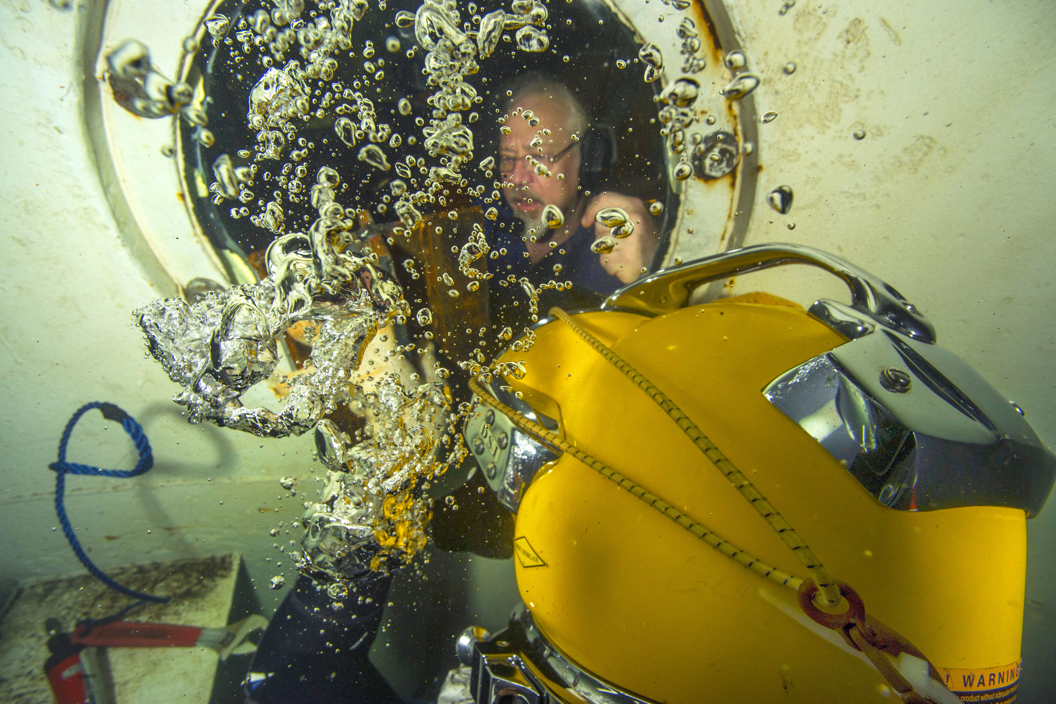 Michael Pett, top, specialist underwater welding engineer, critiques