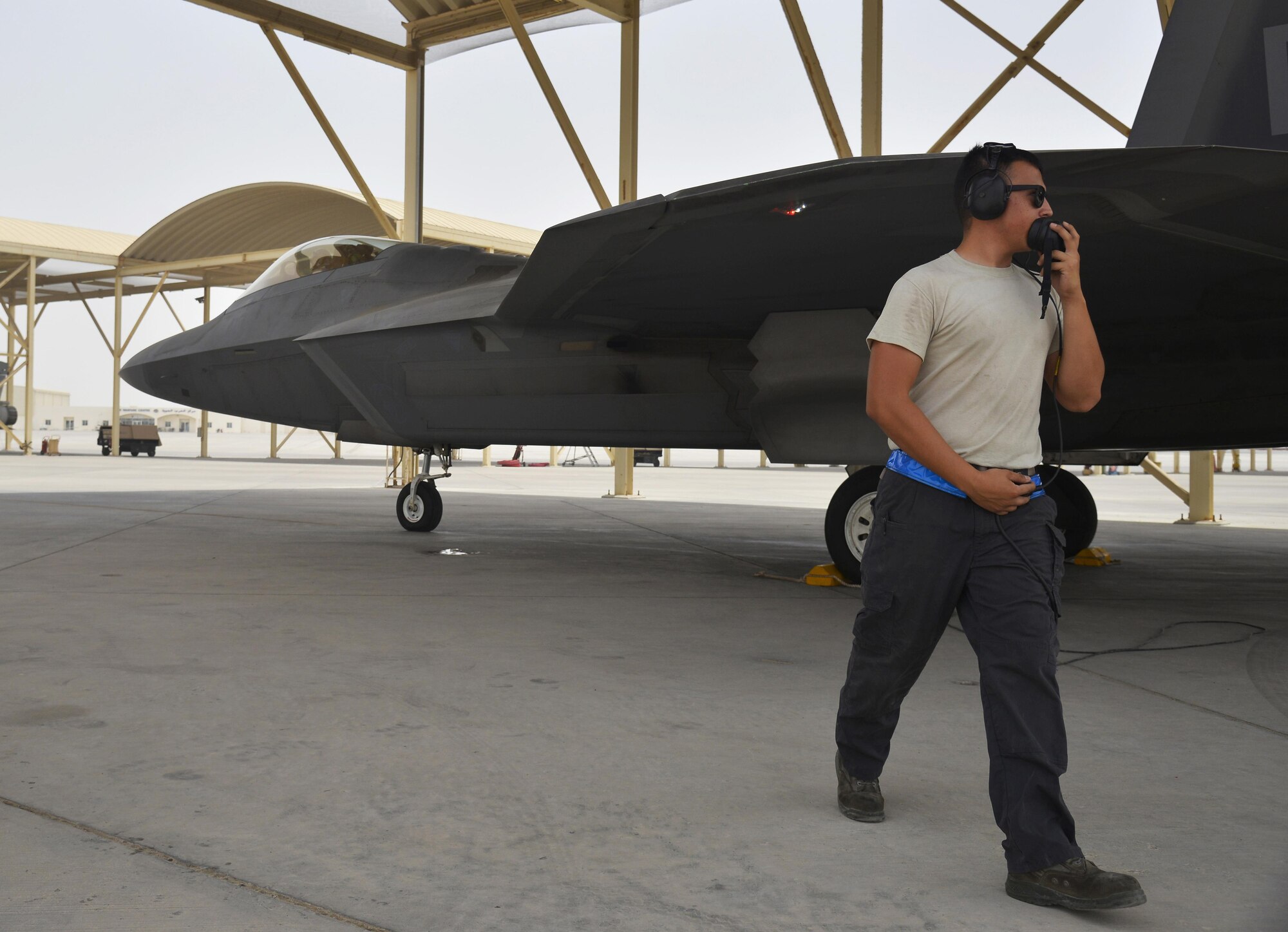 A crew chief performs prelaunch procedures on an F-22 Raptor at an undisclosed location in Southwest Asia July 9, 2015. The F-22 is a fifth-generation aircraft and is designed to engage in air-to-air and air-to-ground missions. (U.S. Air Force photo/Tech. Sgt. Christopher Boitz)