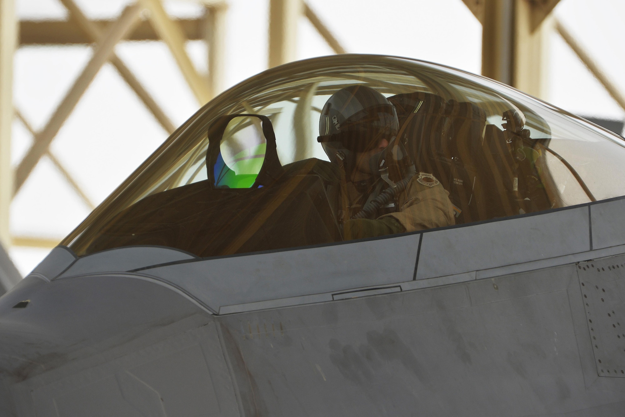 An F-22 Raptor pilot prepares to taxi to the runway at an undisclosed location in Southwest Asia July 9, 2015. The F-22, a critical component of the Global Strike Task Force, is designed to project air dominance, rapidly and at great distances and defeat threats attempting to deny access to our nation's military forces. (U.S. Air Force photo/Tech. Sgt. Christopher Boitz)