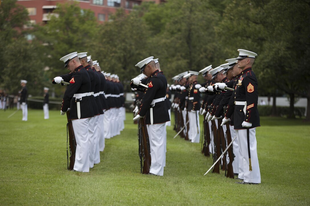 U.S. Marines with Marine Barracks Washington perform during a sunset parade at the Marine Corps War Memorial, Arlington, Va., July 14, 2015. Dr. Jamie M. Morin, Director, Cost Assessment and Program Evaluation, was the guest of honor for the parade, and Lt. Gen. Robert E. Schmidle, principal deputy director Assessment and Program Evaluation, was the hosting official. Since September 1956, marching and musical units from Marine Barracks Washington, D.C., have been paying tribute to those whose “uncommon valor was a common virtue” by presenting sunset parades in the shadow of the 32-foot high figures of the United States Marine Corps War Memorial. (U.S. Marine Corps photo by Lance Cpl. Hailey D. Stuart/Released)