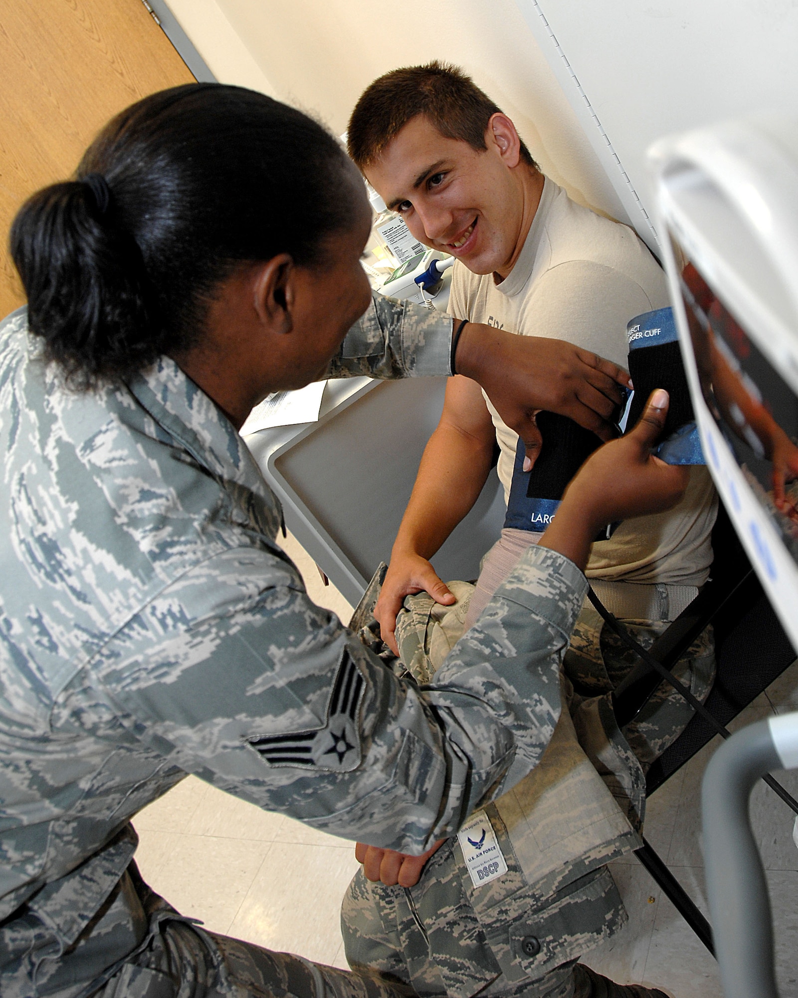 Senior Airman Brittany Prichett takes Airman 1st Class Ronald Frost's blood pressure July 12 in the new Urgent Care Center at Wilford Hall Medical Center, Lackland Air Force Base, Texas. The UCC replaced the Wilford Hall emergency room which closed July 1, 2011. The UCC treats acute minor illnesses and injuries and is not equipped or staffed to handle serious cases.  Patients with more severe issues should seek emergency medical care at Brooke Army Medical Center on Ft. Sam Houston or at the nearest emergency room. (U.S. Air Force Photo/SSgt Josie Walck)