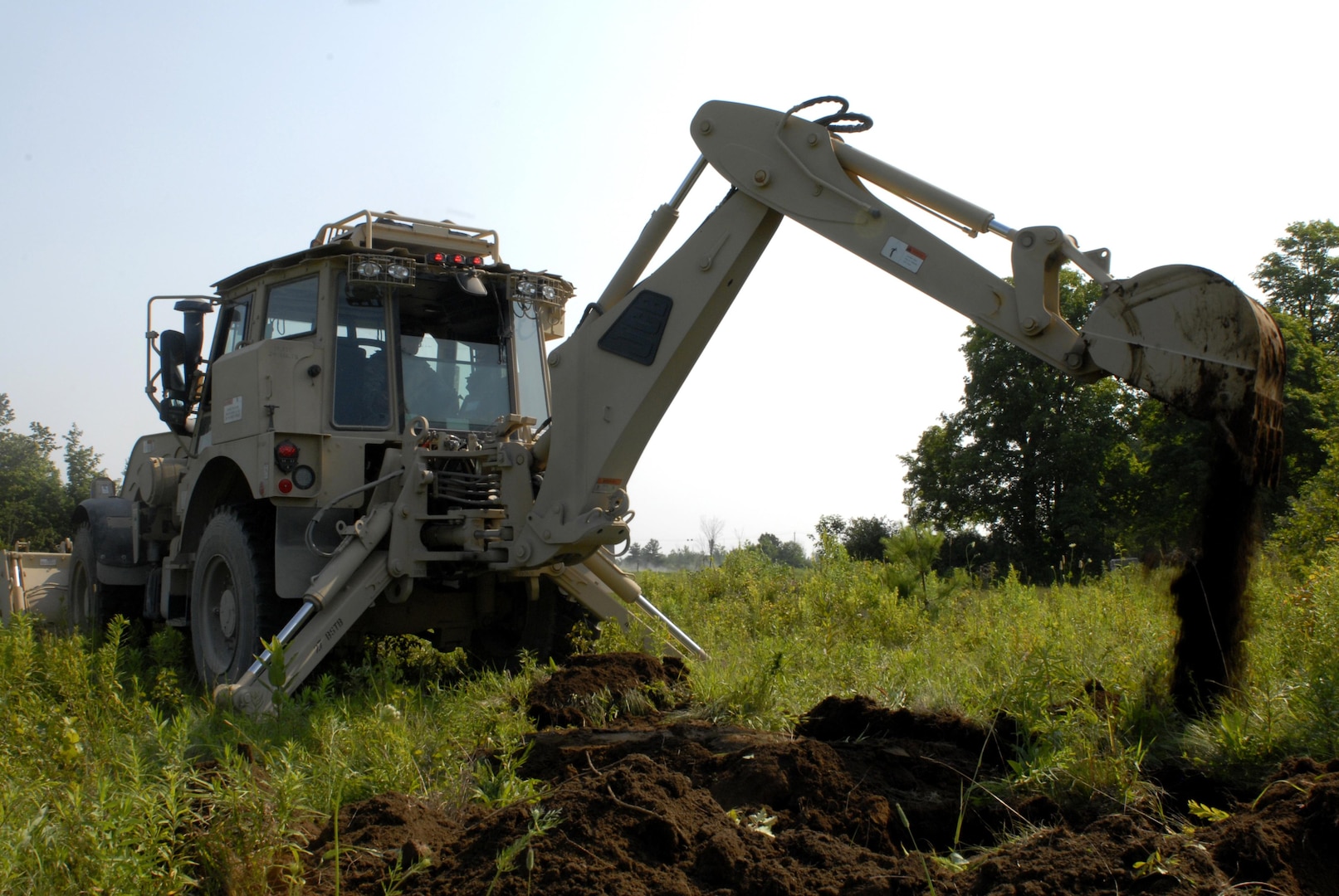 New York Army National Guard Spc. Andrew Paulson, a heavy equipment operator from Amherst, New York, assigned to Company A, 27th Brigade Special Troops Battalion,  operates a High Mobility Engineer Excavator (HMEE) to construct a fighting position during the 27th Infantry Brigade Combat Team Exportable Combat Training Capability (XCTC) exercise at Fort Drum on July 13, 2015. 