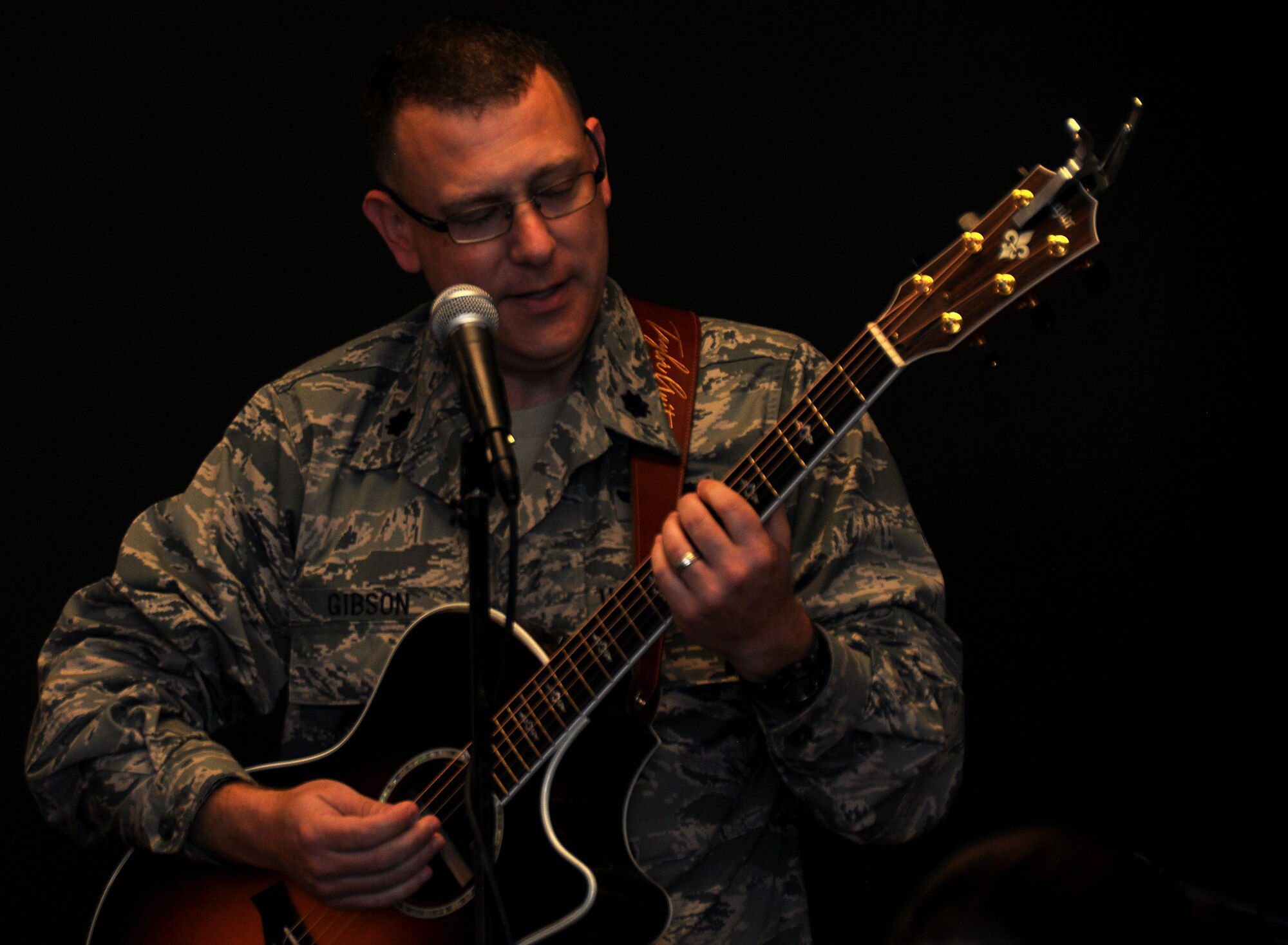 Lt. Col. Chad Gibson, 94th Airlift Wing public affairs officer, plays hymns on the guitar during the unit training assembly chapel service July 12, 2015, at Dobbins Air Reserve Base, Ga. The chapel leads monthly traditional Protestant services and visits regularly with Airmen around the base. (U.S. Air Force photo/ Senior Airman Daniel Phelps)