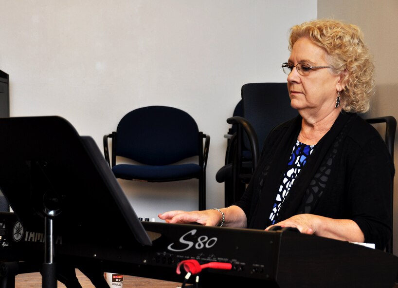 Carol Pope, chapel volunteer, plays hymns on the piano during the unit training assembly chapel service July 12, 2015, at Dobbins Air Reserve Base, Ga. The chapel leads monthly traditional Protestant services and visits regularly with Airmen around the base. (U.S. Air Force photo/ Senior Airman Daniel Phelps)