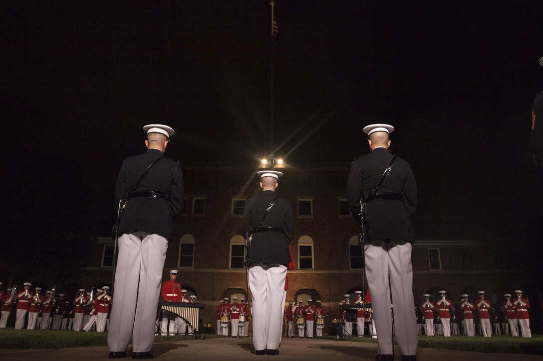 The parade staff stands at ceremonial at ease during a U.S. Marine Drum and Bugle Corps performance at an Evening Parade in Washington, D.C., July 10, 2015. U.S. Marine Corps Gen. Joseph Dunford Jr., commandant of the Marine Corps, was the hosting official for the July 10 evening parade, and the Guest of Honor were eight congressional Marines, to include Sen. Charles Roberts, Sen. Daniel Sullivan, Rep. John Kline, Rep. Michael Coffman, Rep. Scott Rigell, Rep. Paul Cook, Rep. Mike Bost and Rep. Ruben Gallego (U.S. Marine Corps Photo by Lance Cpl. Alejandro Sierras/ Released)
