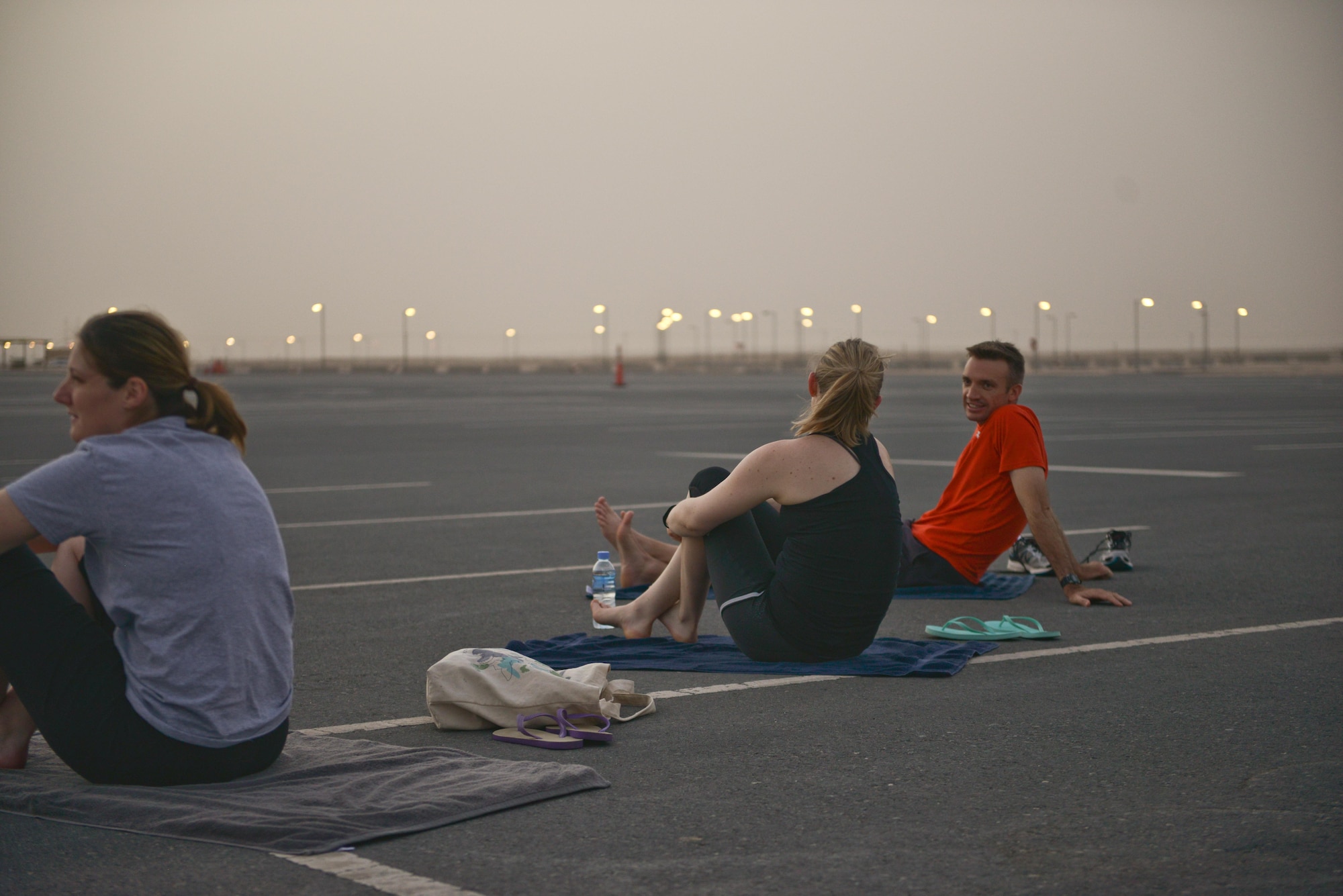 Al Udeid soldiers, sailors, airmen, marines, coalition partners and civilians meet up for the largest Yoga session to take place in Qatar history July 11, 2015 Al Udeid Air Base, Qatar. This event opened its doors to all levels of practitioners from novice to expert. It allowed the fine men and women assigned to Al Udeid Air Base to relax and enjoy a different kind of exercise in a neutral environment. (U.S. Air Force photo/Staff Sgt. Alexandre Montes)