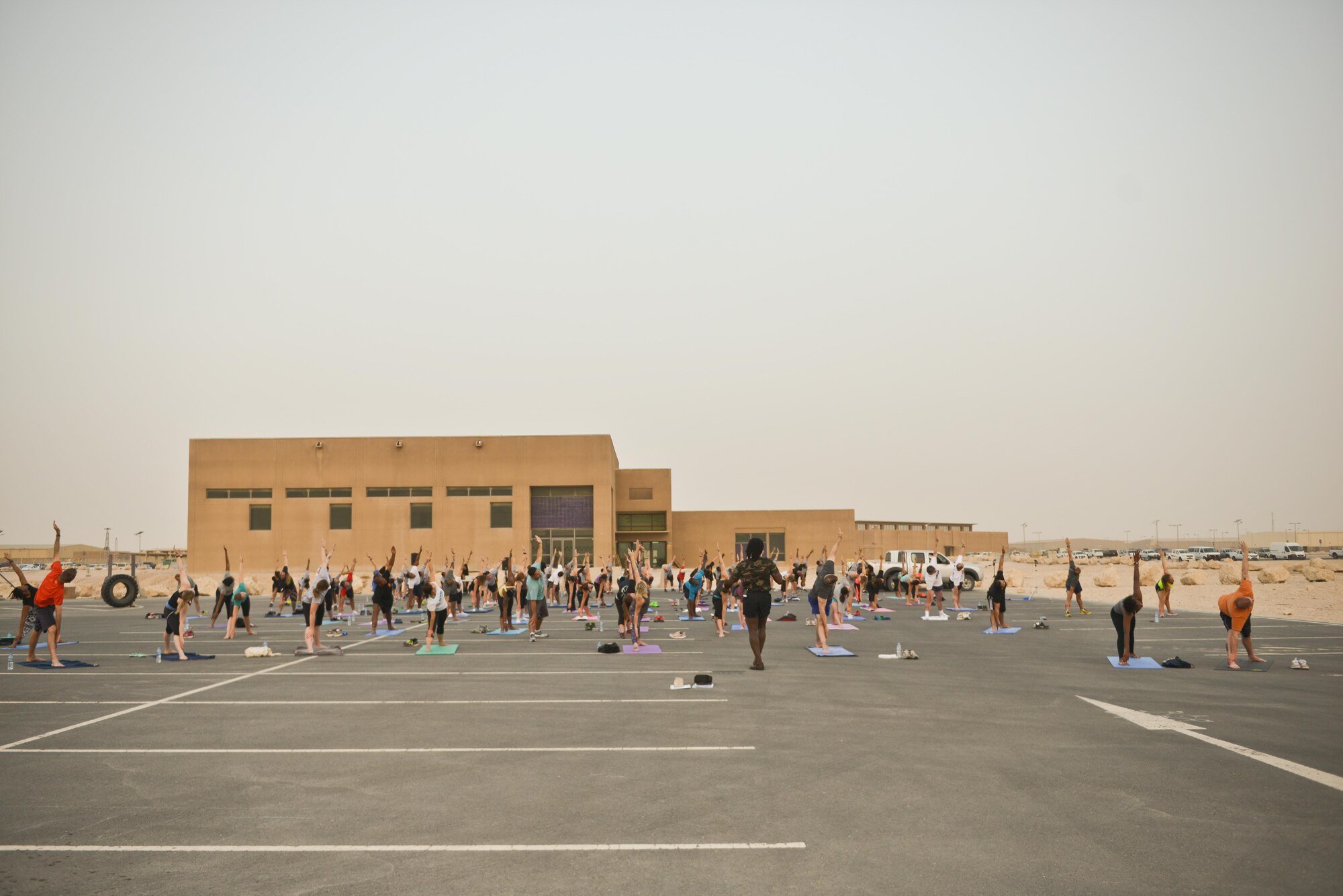 Over 100 Al Udeid soldiers, sailors, airmen, marines, coalition partners and civilians meet up for the largest Yoga session to take place in Qatar history July 11, 2015 Al Udeid Air Base, Qatar. This event opened its doors to all levels of practitioners from novice to expert. It allowed the fine men and women assigned to Al Udeid Air Base to relax and enjoy a different kind of exercise in a neutral environment. (U.S. Air Force photo/Staff Sgt. Alexandre Montes)