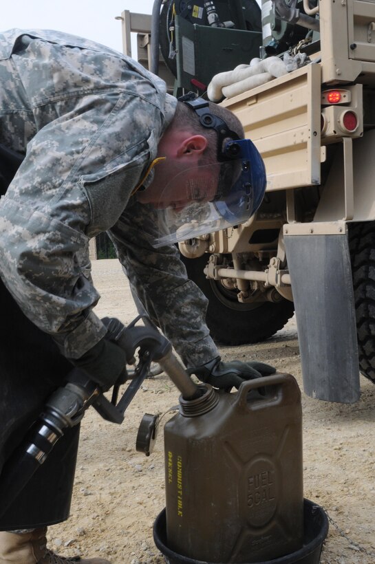 U.S. Army Pfc. Joshua Smith, a petroleum supply specialist with the 960th Quartermaster Company, fills a fuel can during the Combat Support Training Exercise on Fort McCoy, Wis., June 15. (U.S. Army photo by Sgt. Beth Raney, 363rd Public Affairs Detachment)