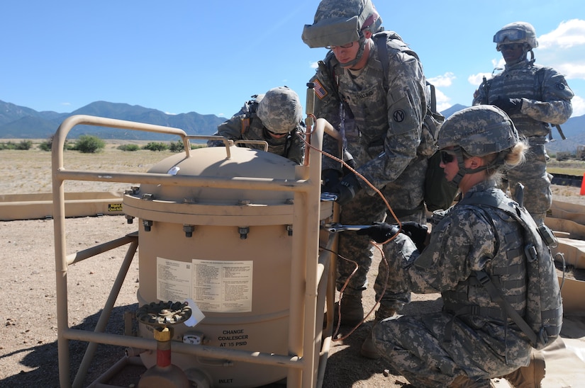 U.S. Army Reserve Sgt. Vanessa Lauterwasser, Spc. Melissa Stark and Spc. Tyler Stelling work to remove the lid of a filter separator tank during the Quartermaster Liquid Logistics Exercise (QLLEX) on Fort Huachuca, Ariz., June 10, 2015. The three soldiers are petroleum supply specialists assigned to the 383rd Quartermaster Company from St. Charles, Mo. The unit is tasked with running the “bag farm,” where fuel is stored during the QLLEX. (U.S. Army Reserve photo by Capt. Jill O’Dell, 364th Press Camp Headquarters)