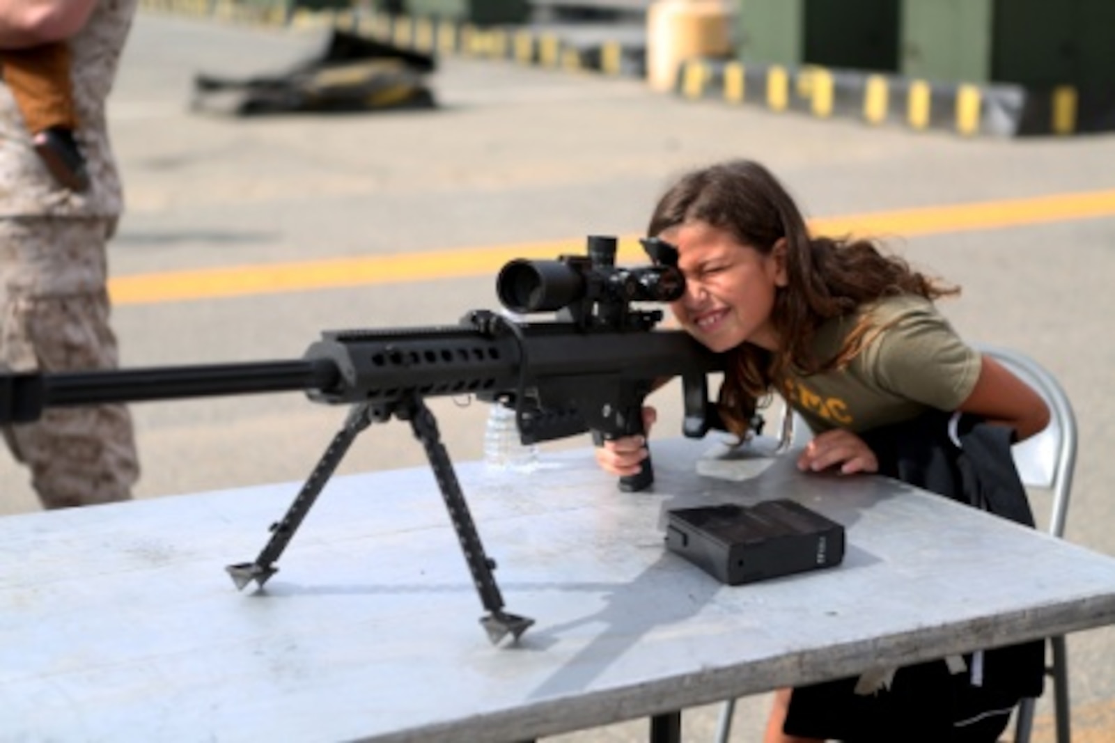 Haliyah, the daughter of Staff Sgt. Henry Hernandez, looks through the scope on a .50 caliber Special Application Scoped Rifle at a family day held by 7th Engineer Support Battalion, 1st Marine Logistics Group, aboard Camp Pendleton, Calif., July 10, 2015. Included in the celebration were bouncy houses and displays that allowed them to look at things like sniper rifles, armored vehicles and Explosive Ordnance Disposal gear.