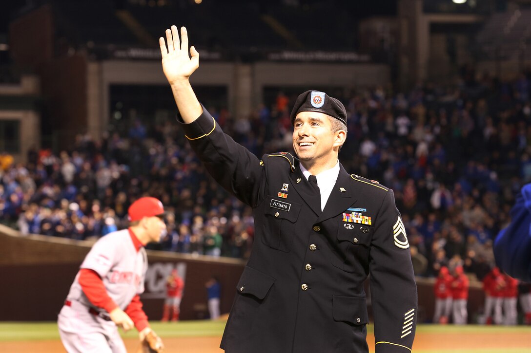 Army Reserve Sgt. 1st Class David Fittanto waves to a crowd of more than 29,000 Chicago Cubs and Cincinnati Reds fans during a game at Wrigley Field, April 15. The Cubs recognized Fittanto for his service, on the field, during a Wednesday night game there. (U.S. Army photo by Anthony L. Taylor/Released)