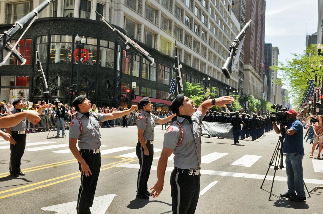 Junior Reserve Officers Training Corps cadets pause at the reviewing stand for the City of Chicago Memorial Day parade to perform a drill routine there, May 23. More than 45 JROTC schools and academies were represented there an estimated 6,000 cadets marching in the parade. (U.S. Army photo by Sgt. Aaron Berogan)