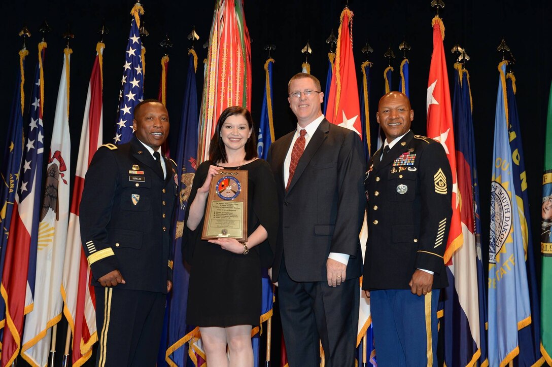 Wendy Rich (second left), a tools and parts attendant for Army Maintenance Support Activity 38, and Eric Hollinger (second right), a heavy mobile equipment supervisor at AMSA 38, pose with their Army supply excellence award which was presented to them at the 11th Annual Chief of Staff of the Army’s Combined Logistics Excellence Awards ceremony, hosted at the Pentagon, Arlington, Virginia, June 10. Joining them in the photo are Brig. Gen. Ronald Kirklin (left) commandant, U.S. Army Quartermaster School and Command Sgt. Maj. Jimmy Sellers (right), regimental command sergeant major, U.S. Army Quartermaster School.